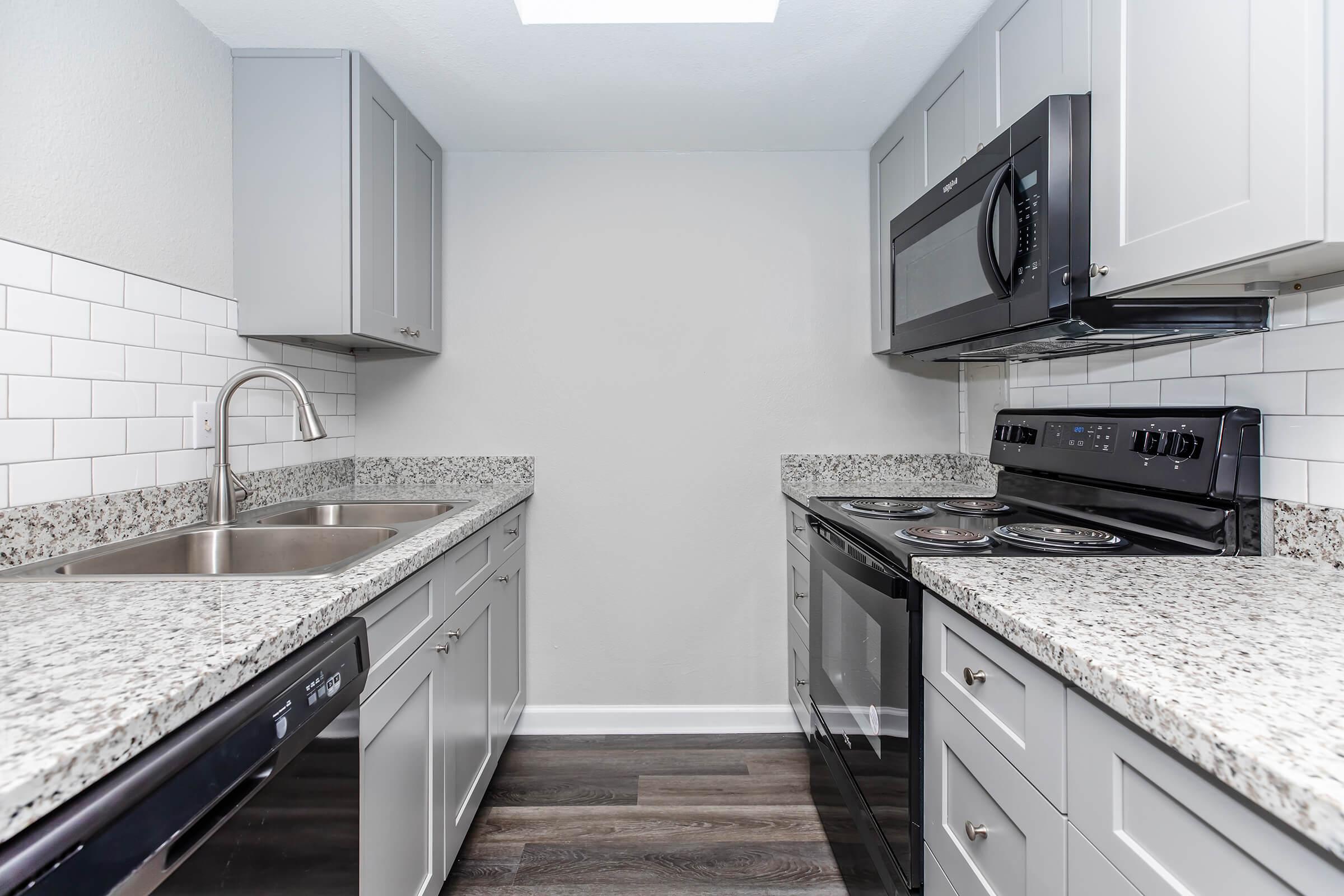 a kitchen with a stove and a sink