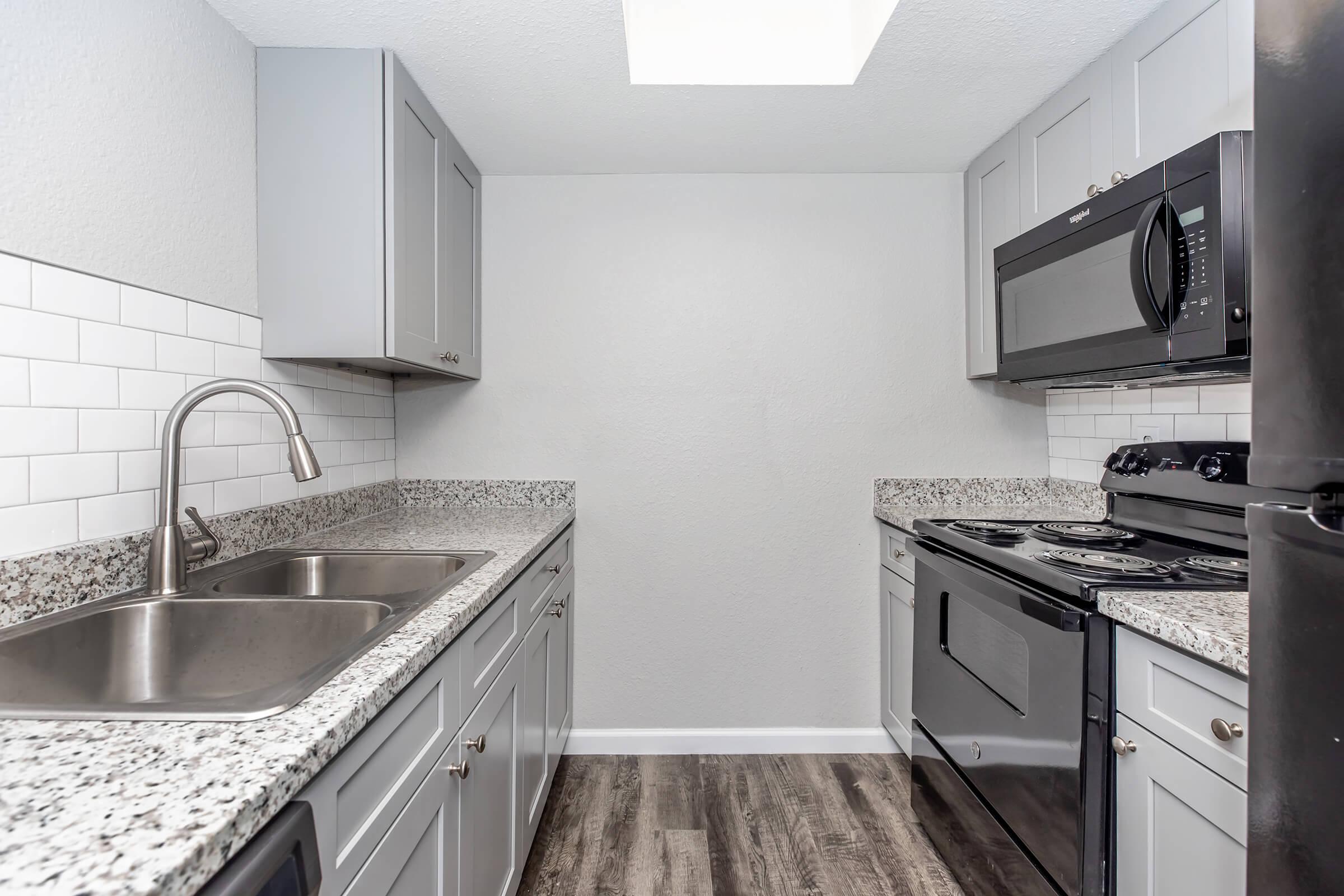 a kitchen with a stove sink and refrigerator