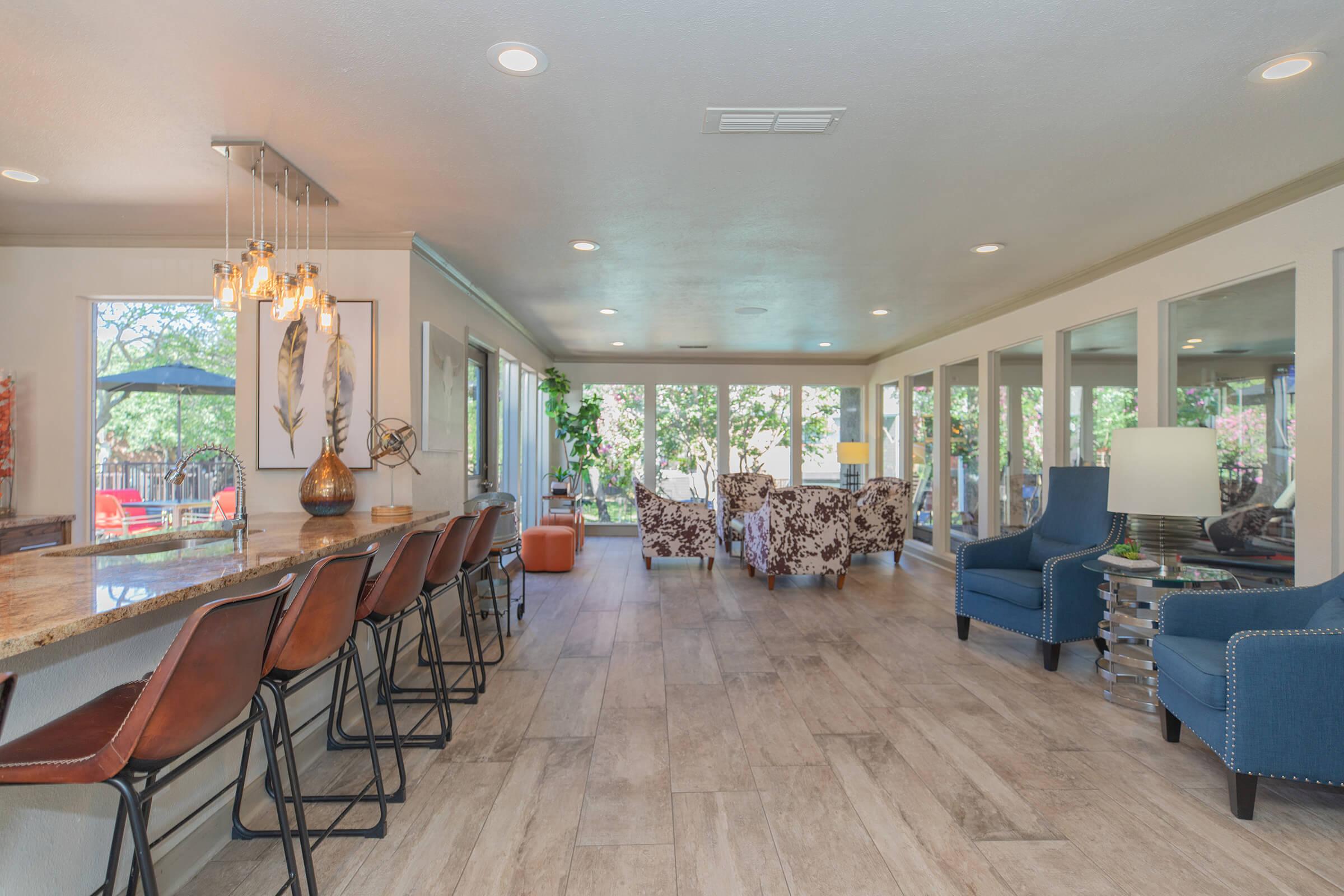 a living room filled with furniture and a large window