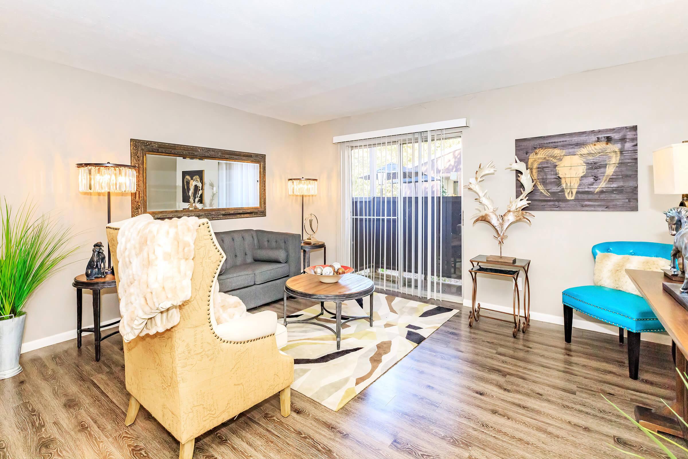 a living room filled with furniture and a blue chair