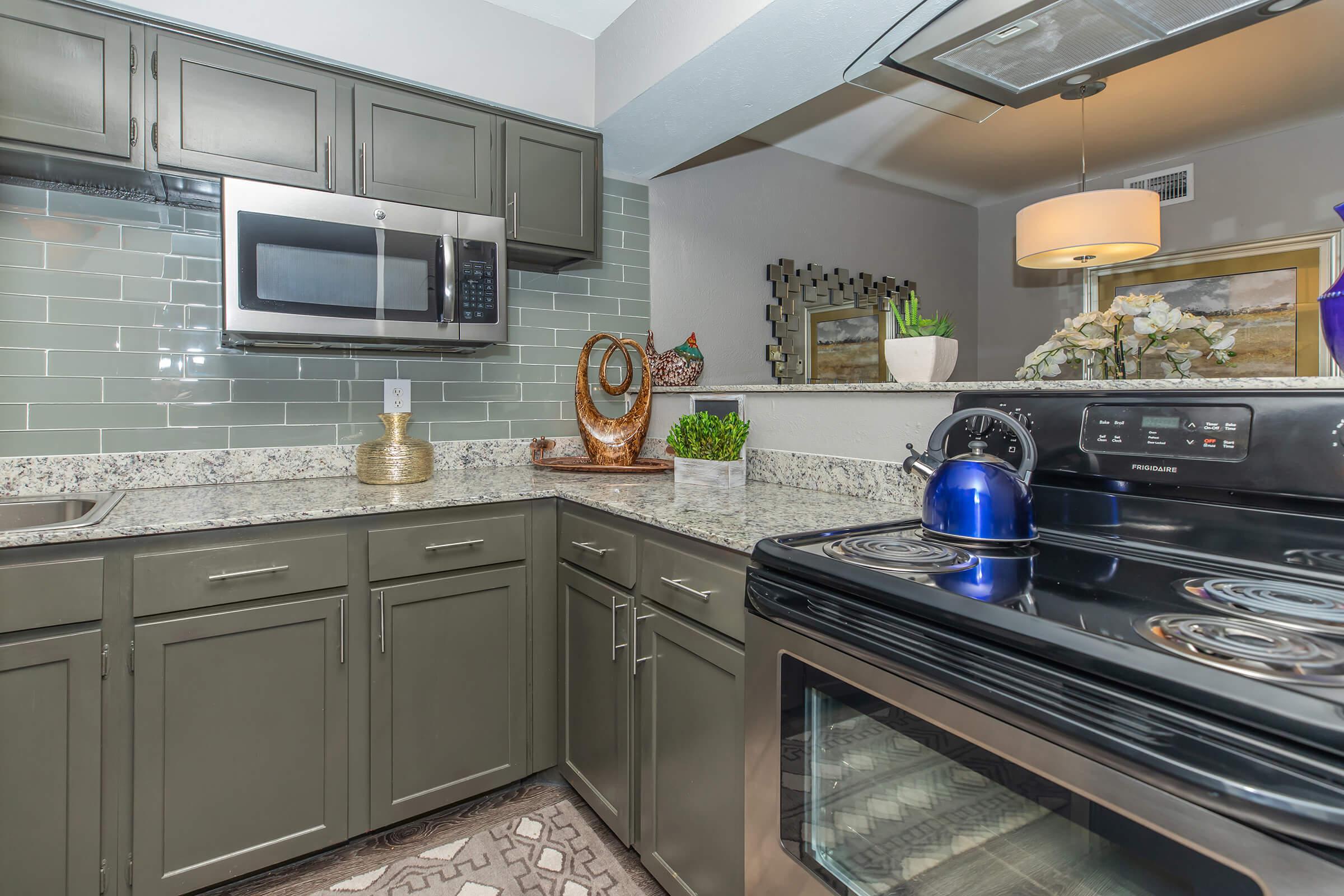 a stove top oven sitting inside of a kitchen