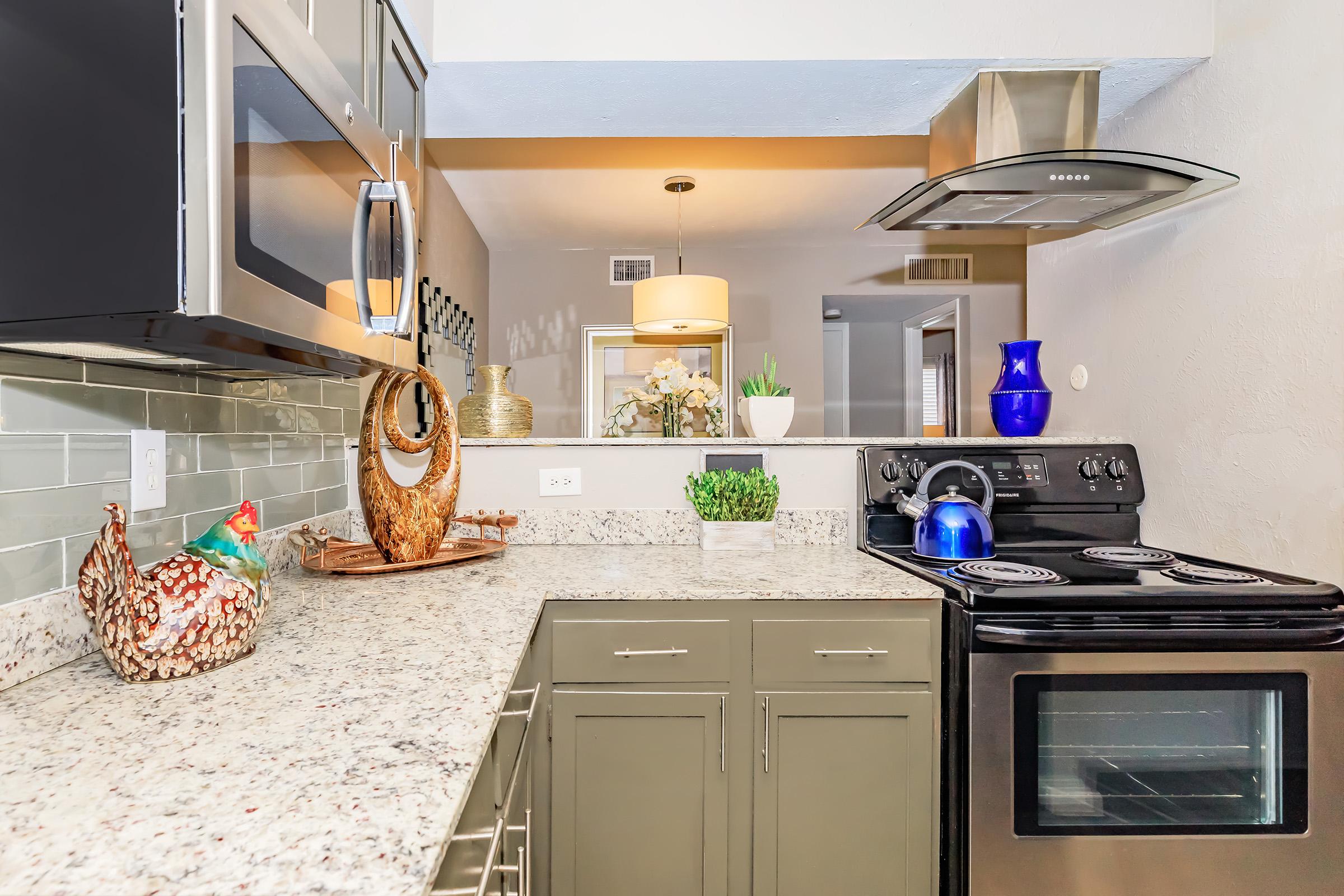 a stove top oven sitting inside of a kitchen