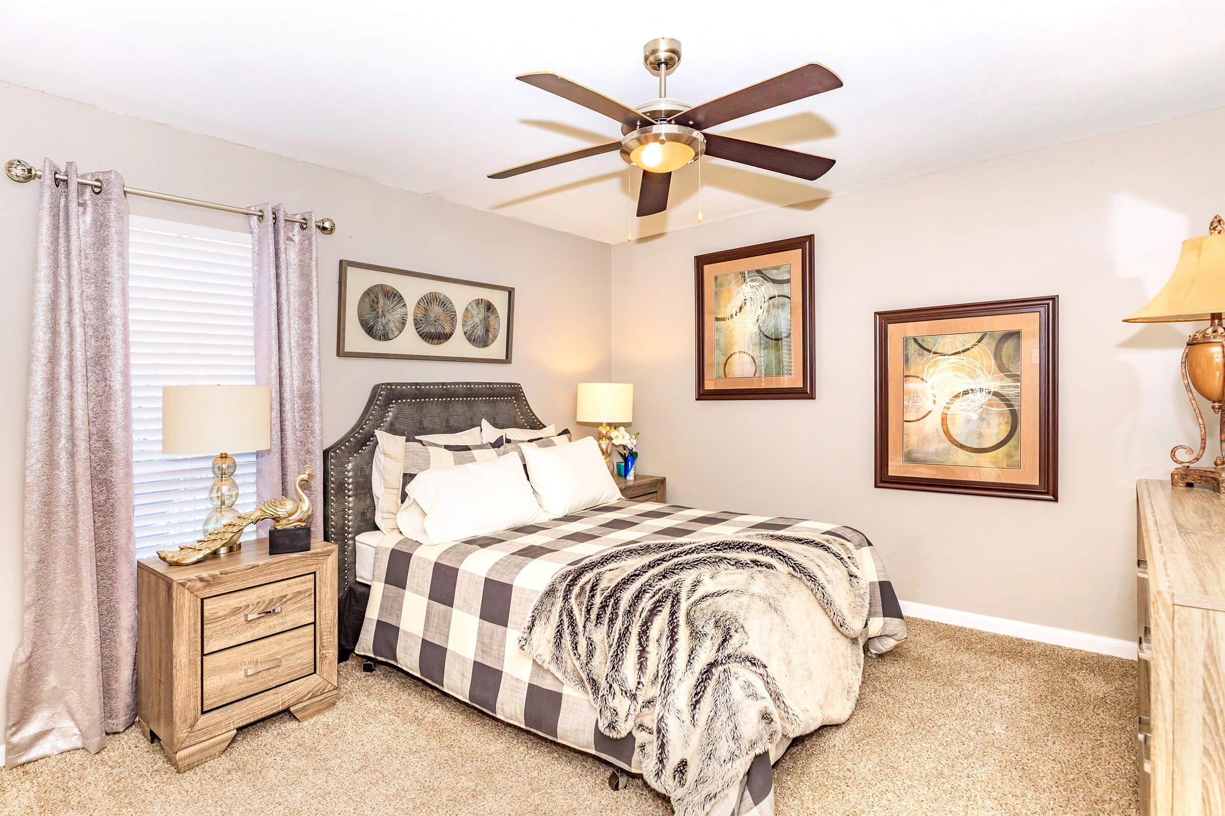 a bedroom with a bed and desk in a room