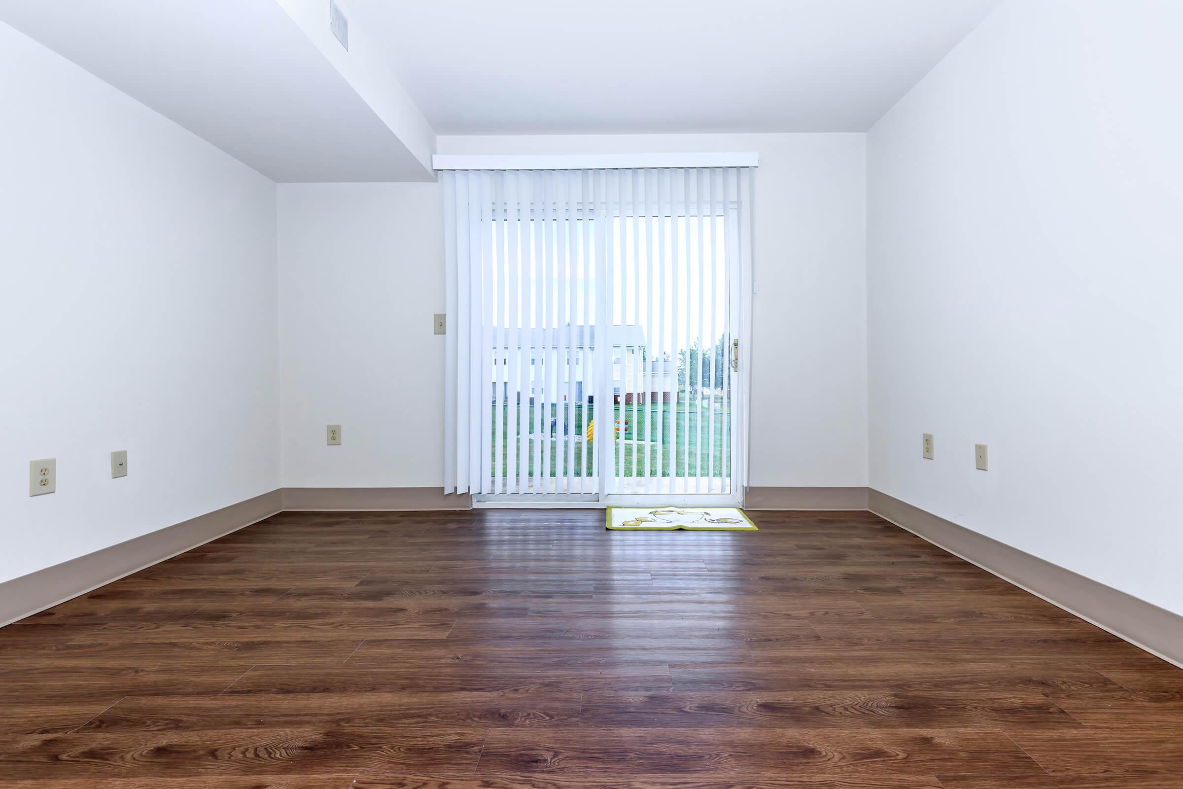 a large empty room with a wooden floor