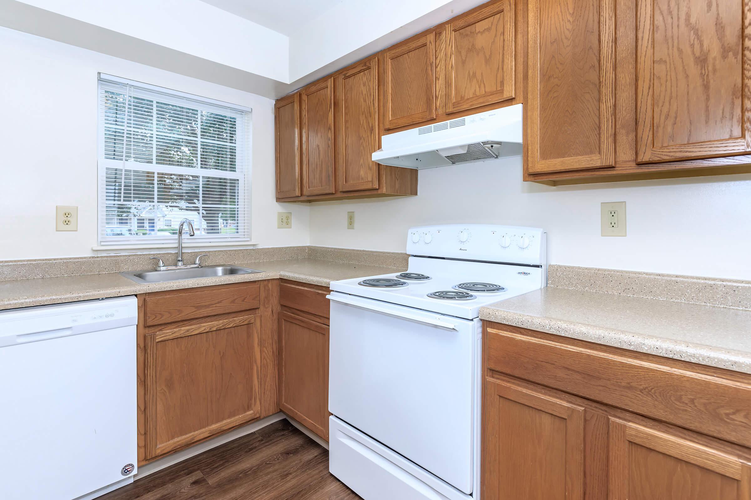 a kitchen with wooden cabinets and a microwave