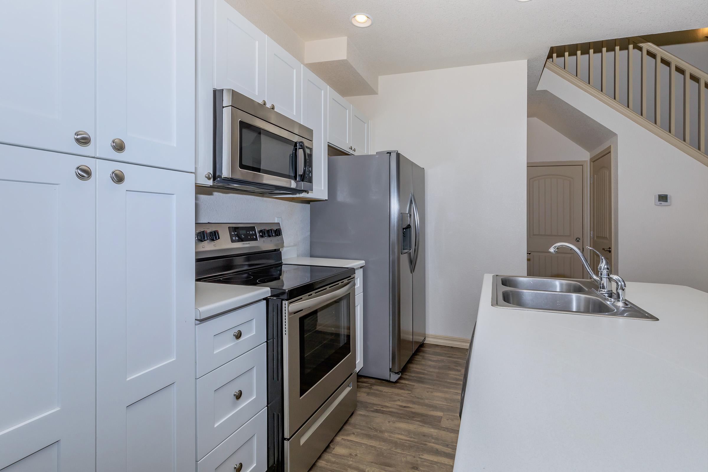 a stove top oven sitting inside of a kitchen