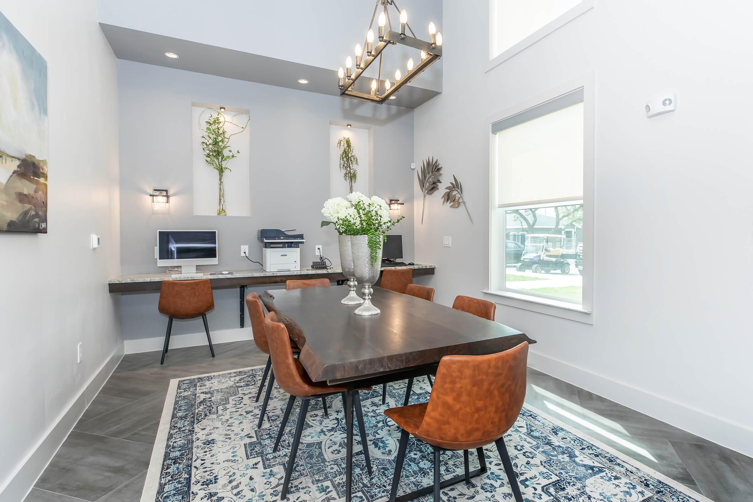 a living room filled with furniture and vase of flowers on a table