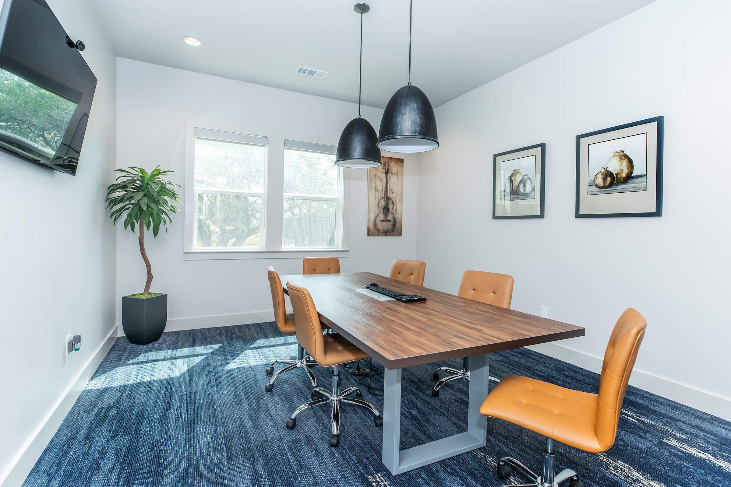 a living area with a desk and chair in a room