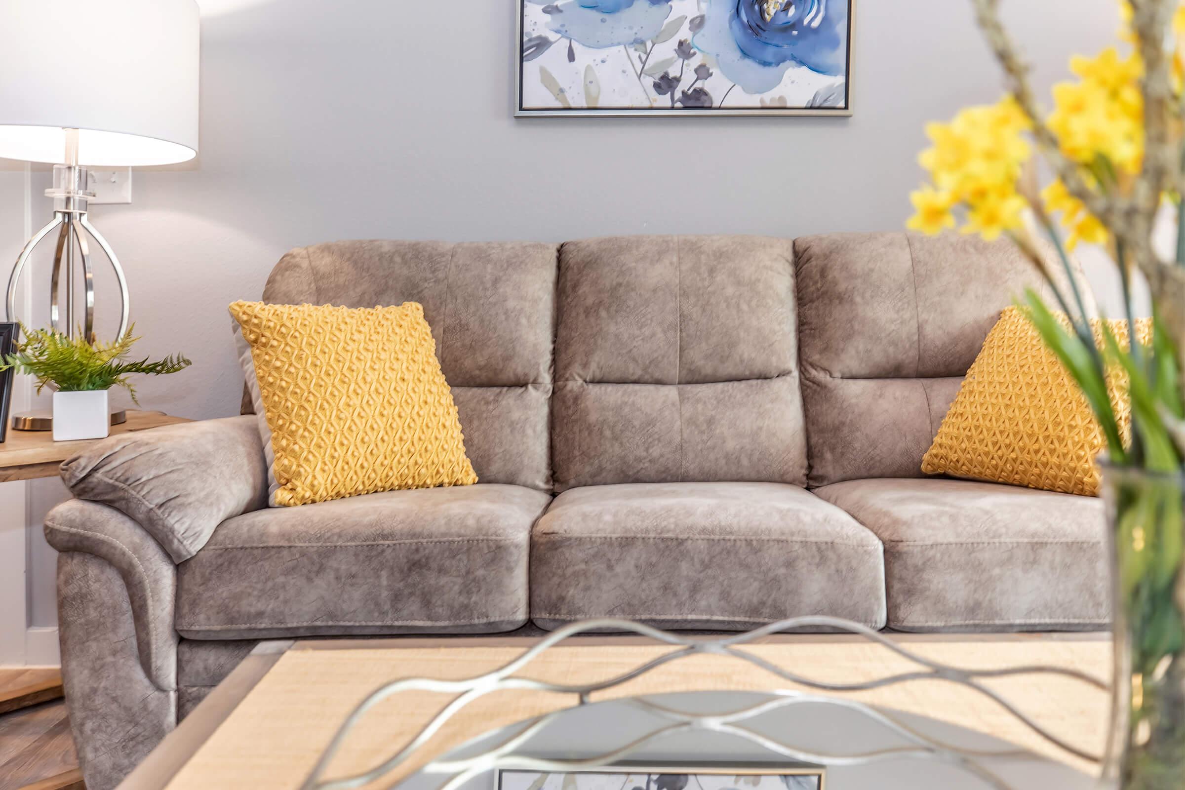 a brown leather couch in a living room