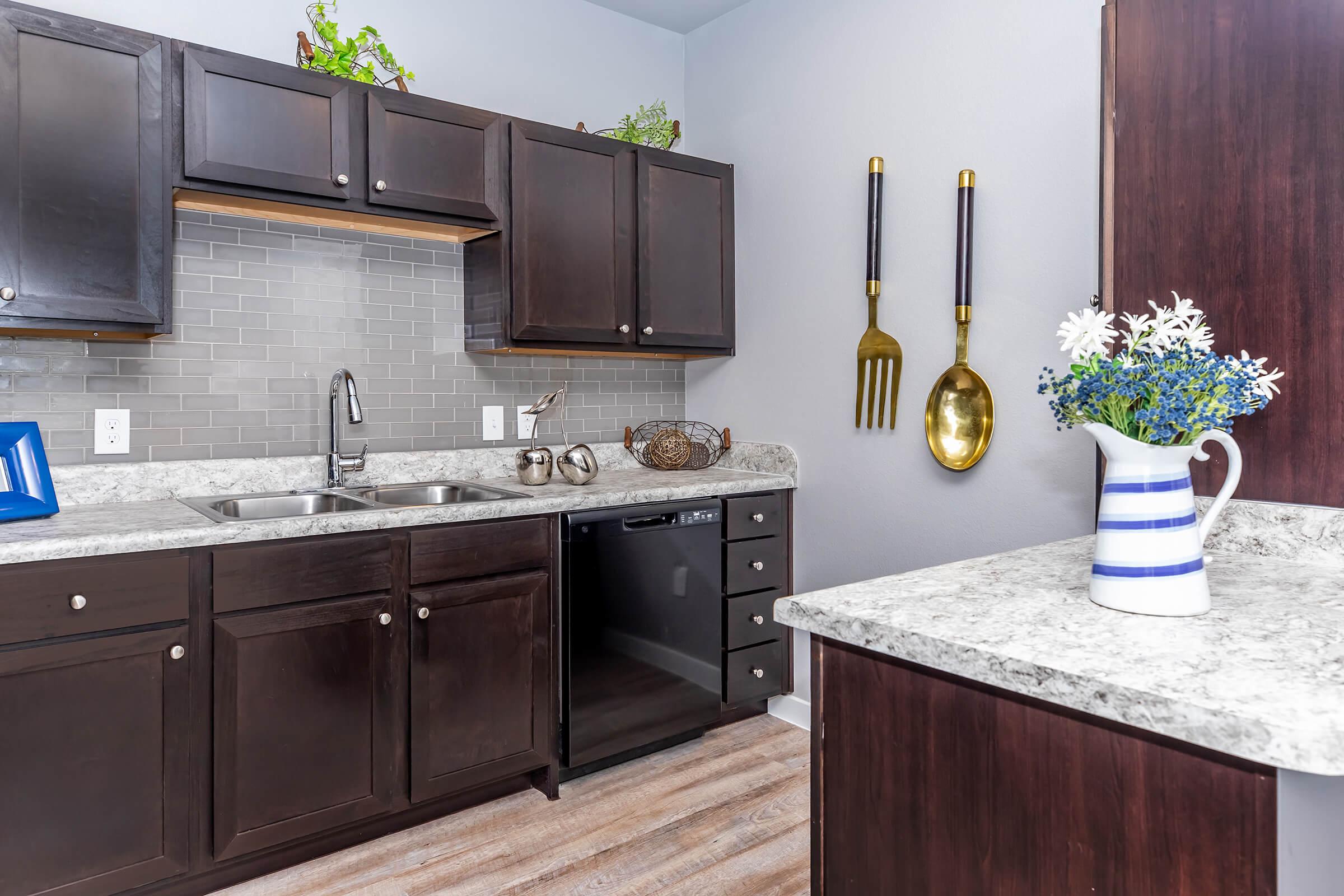 a kitchen with a sink and a mirror