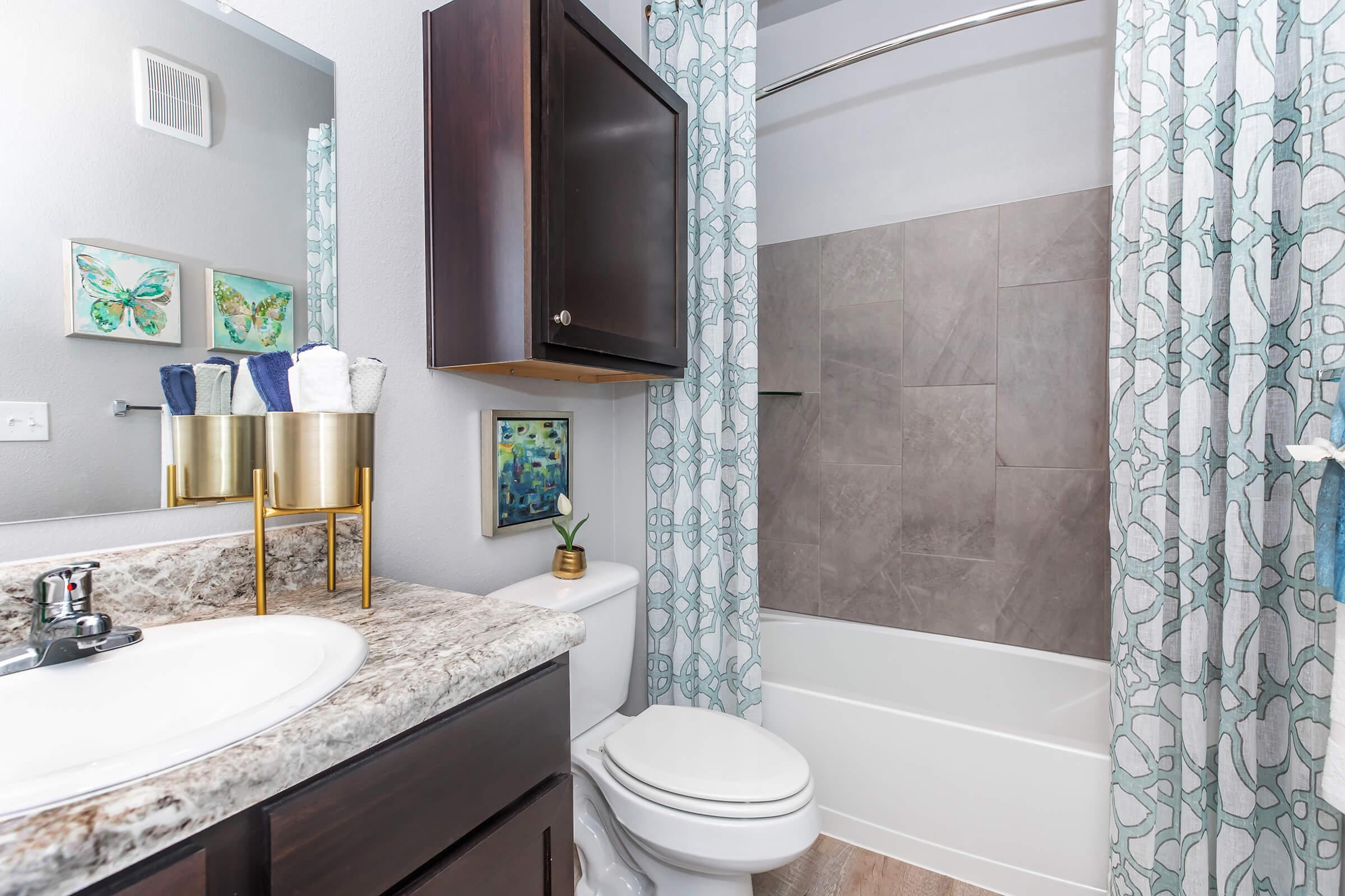 a shower curtain next to a sink