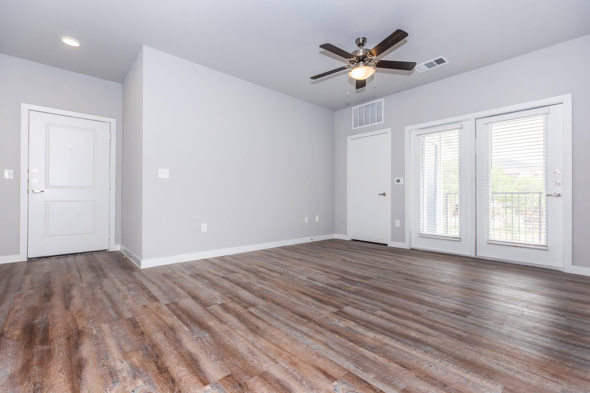 a large empty room with a wood floor