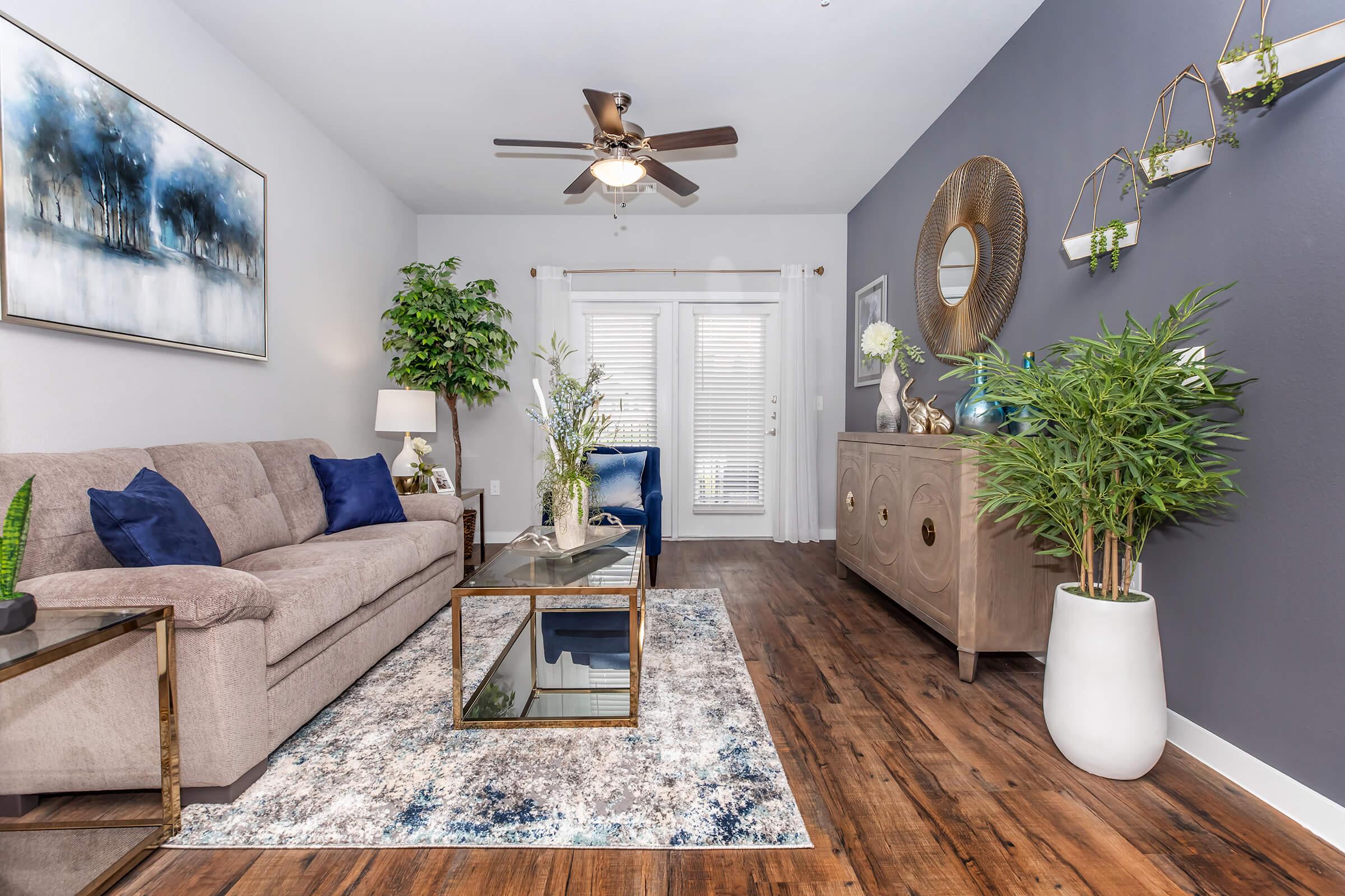 a living room filled with furniture and a large window