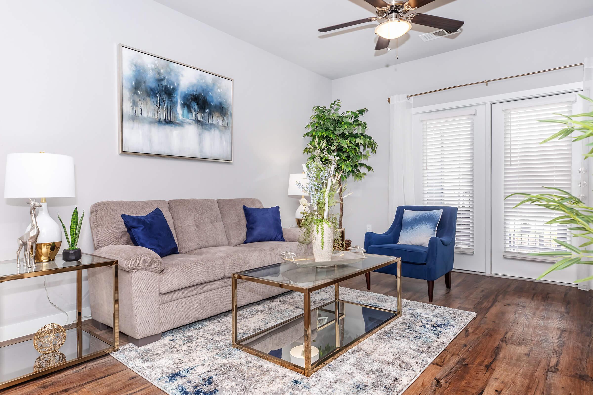 a living room filled with furniture and a large window