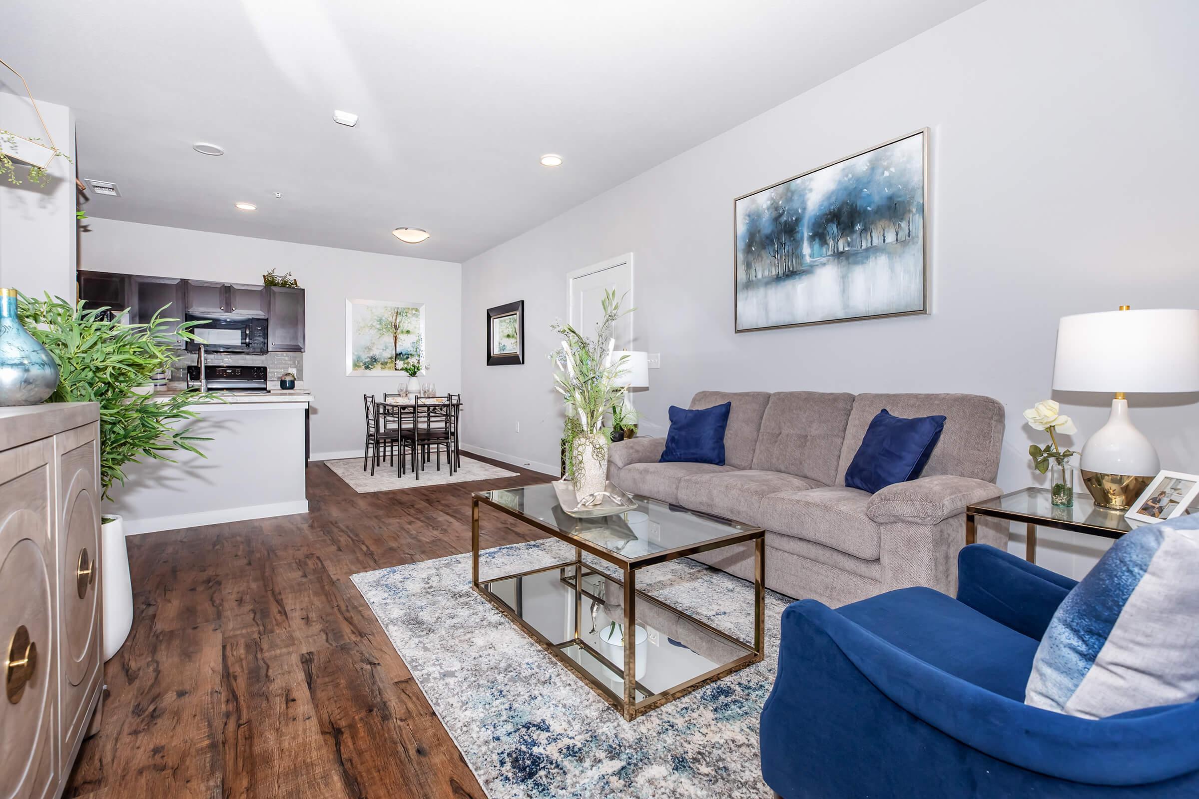 a living room filled with furniture and a large window