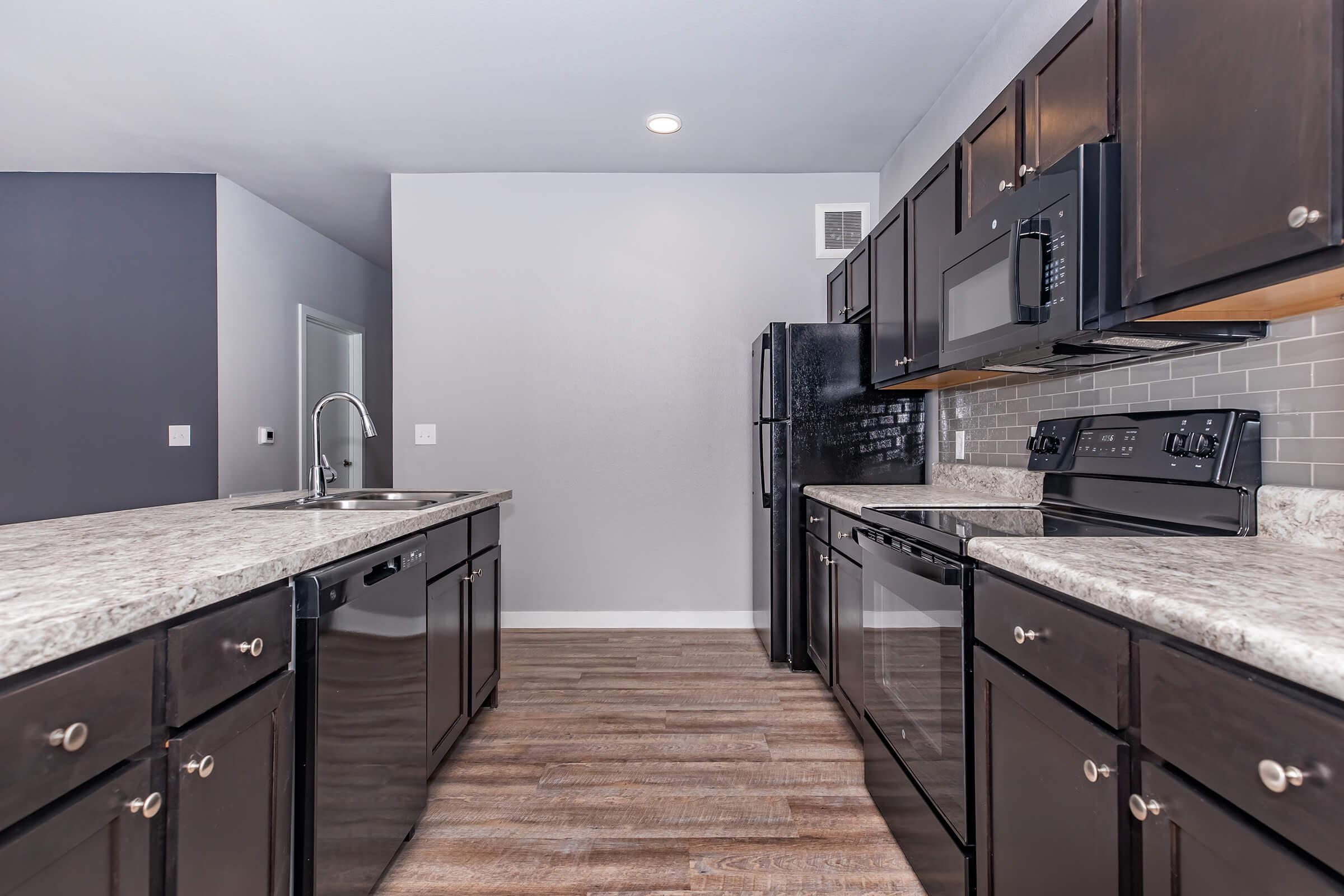 a modern kitchen with stainless steel appliances and wooden cabinets