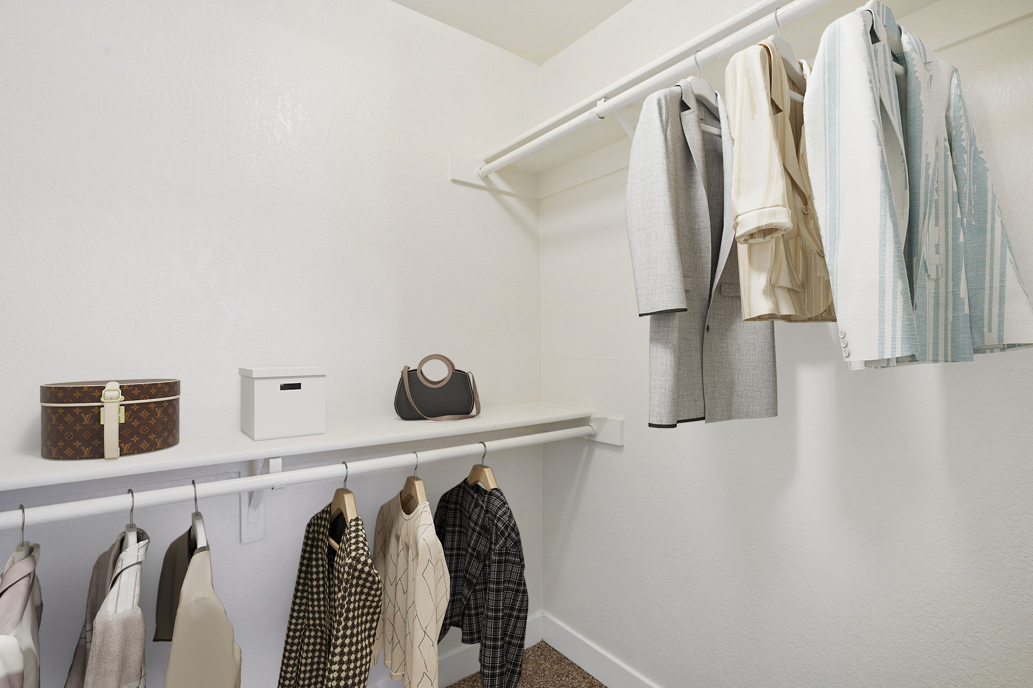 A stylish walk-in closet featuring a collection of neatly hung garments including suits and dresses. On the shelf, there are storage boxes and a handbag. The closet is organized with a neutral color palette, giving it a modern and minimalist aesthetic.