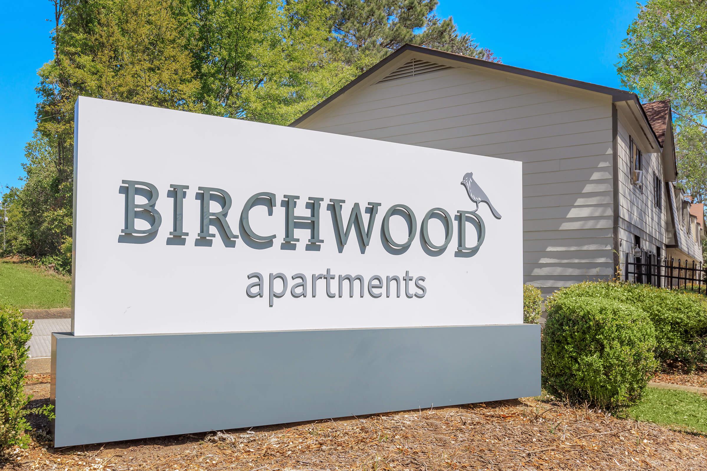 a sign in front of a house