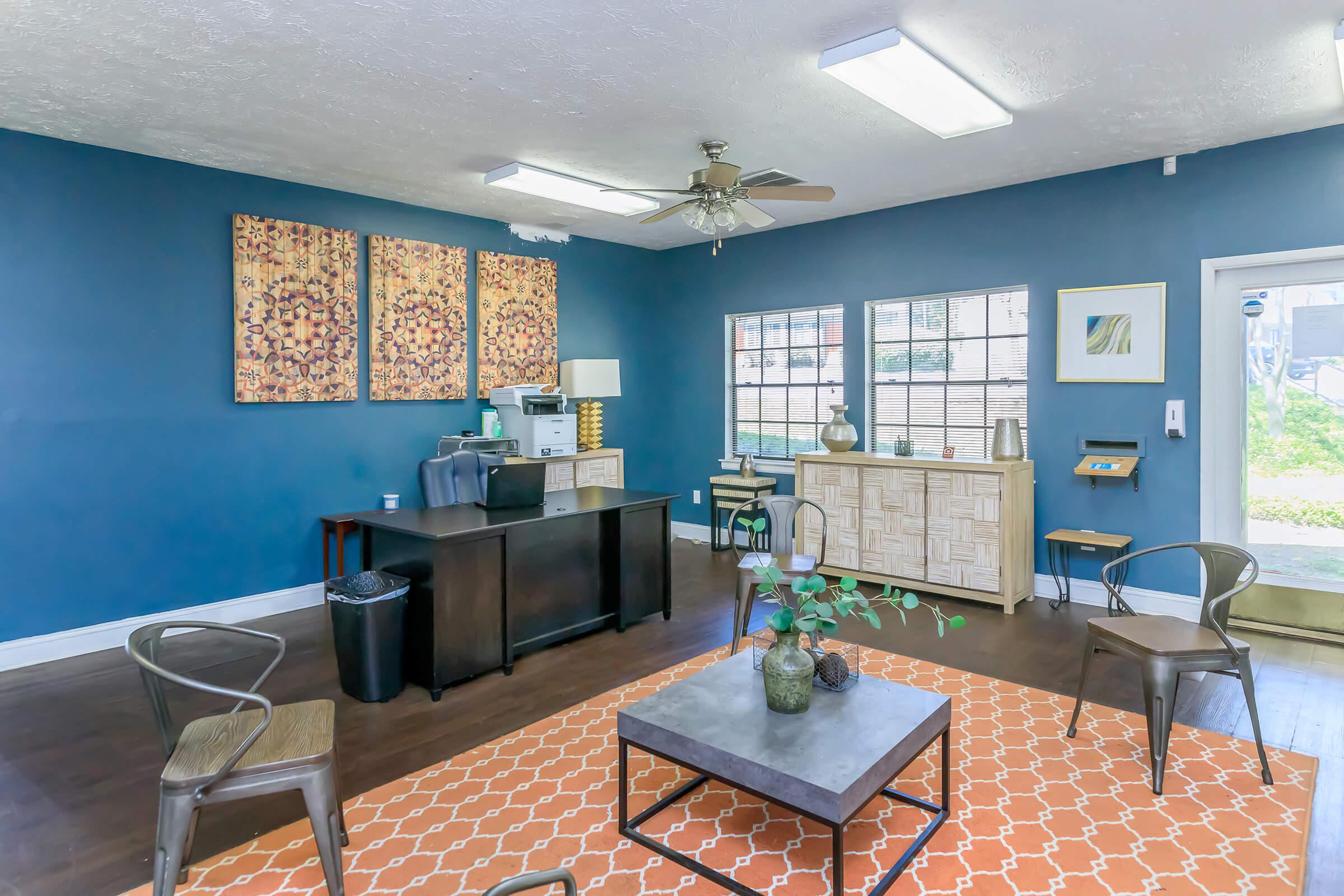 a living room filled with furniture and a large window