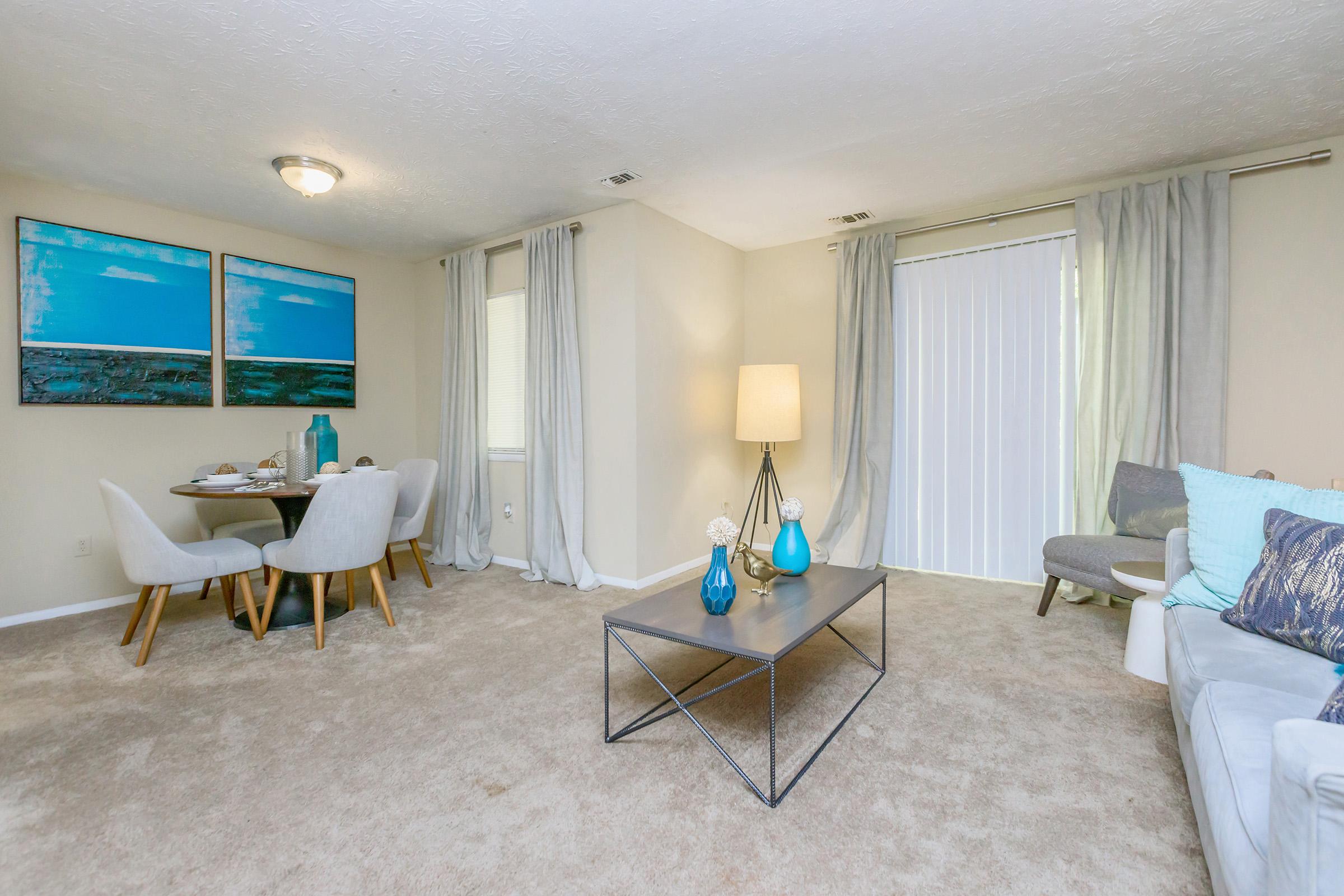 a living room filled with furniture and a flat screen tv