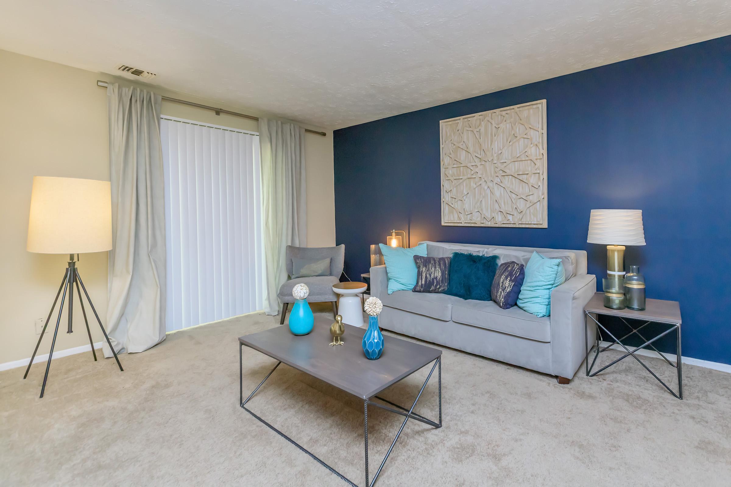 a living room filled with furniture and a lamp