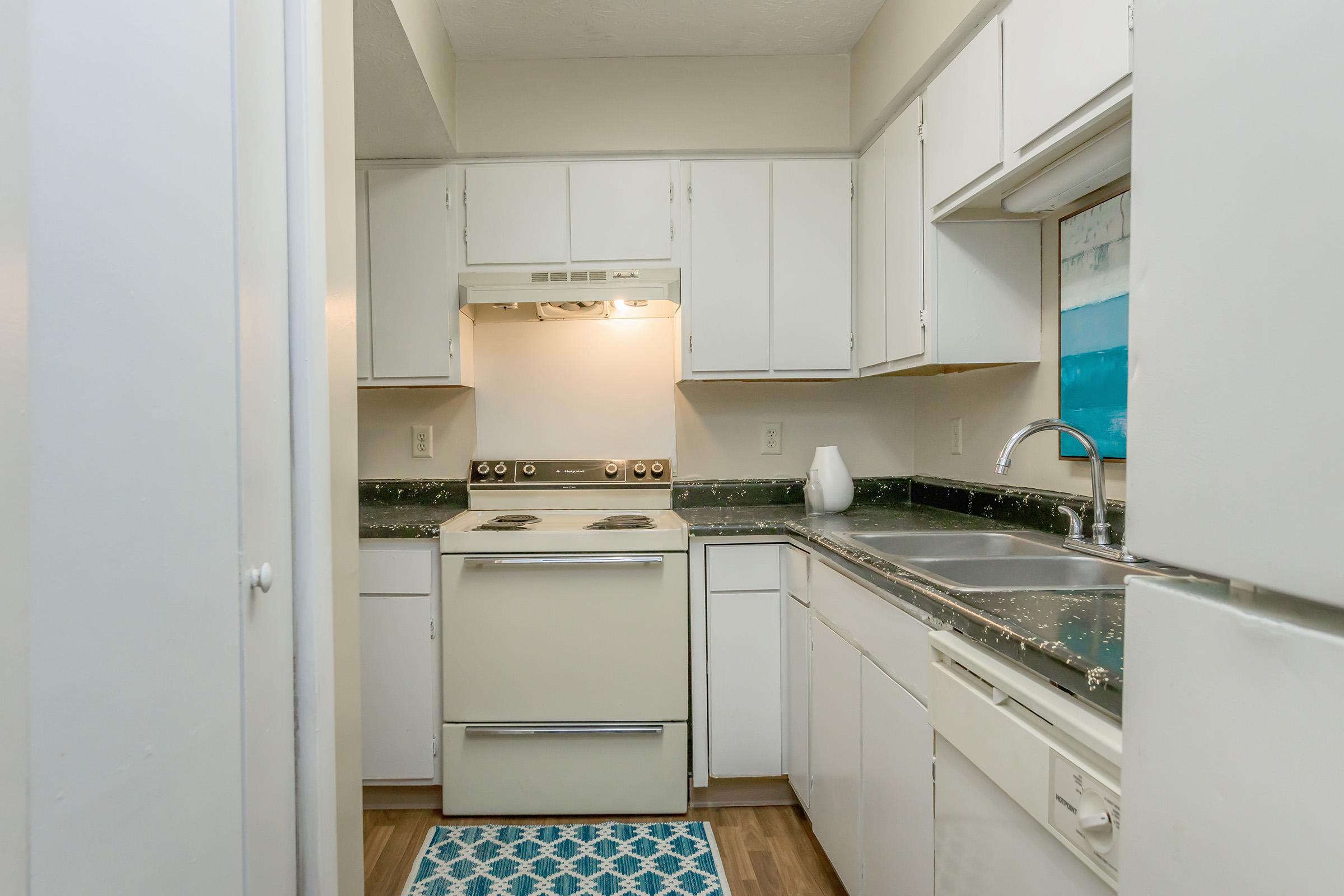 a kitchen with a stove and a refrigerator