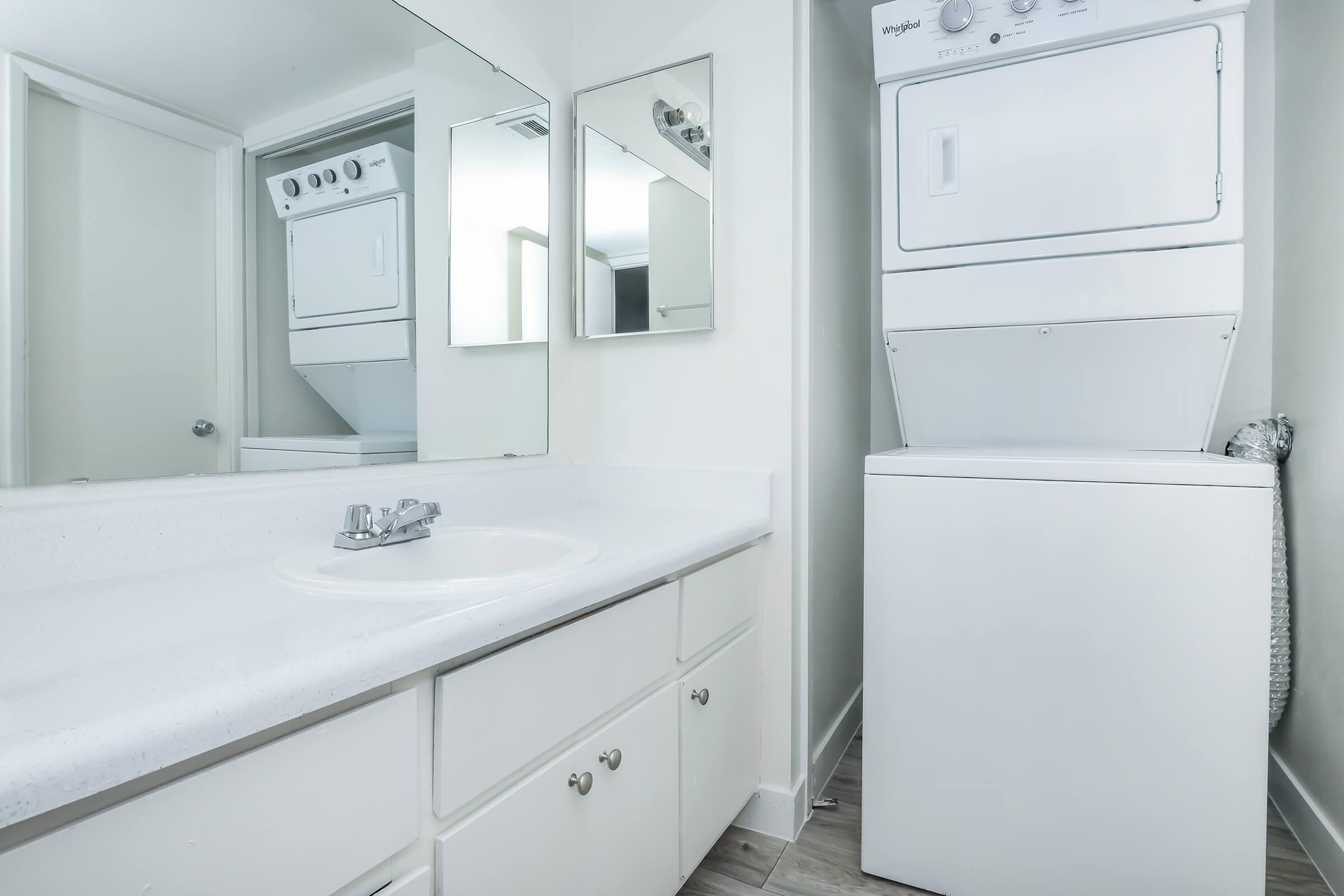 A bathroom with a washer and dryer at Rise at the Meadows.