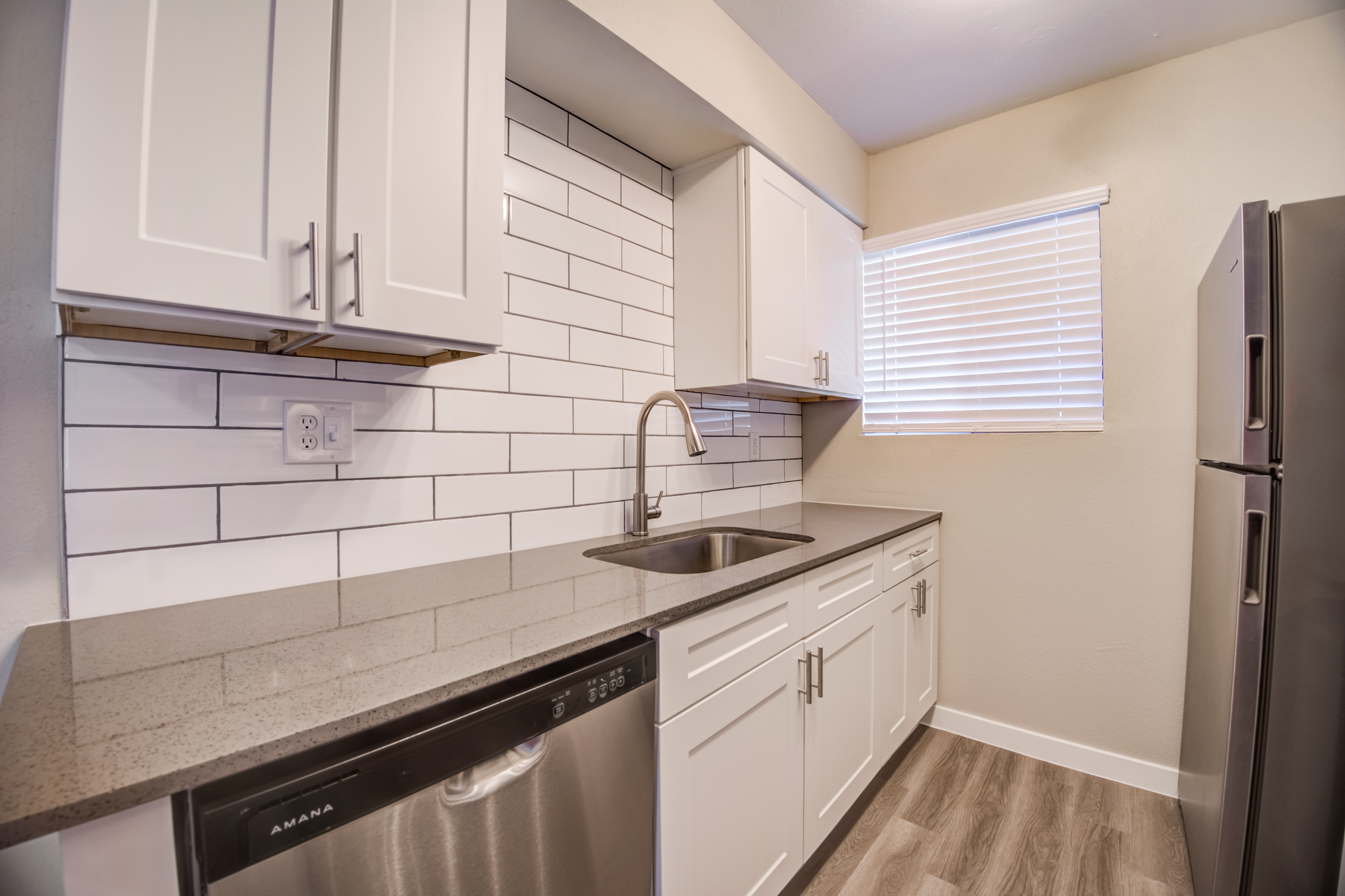 a kitchen with a sink and a window
