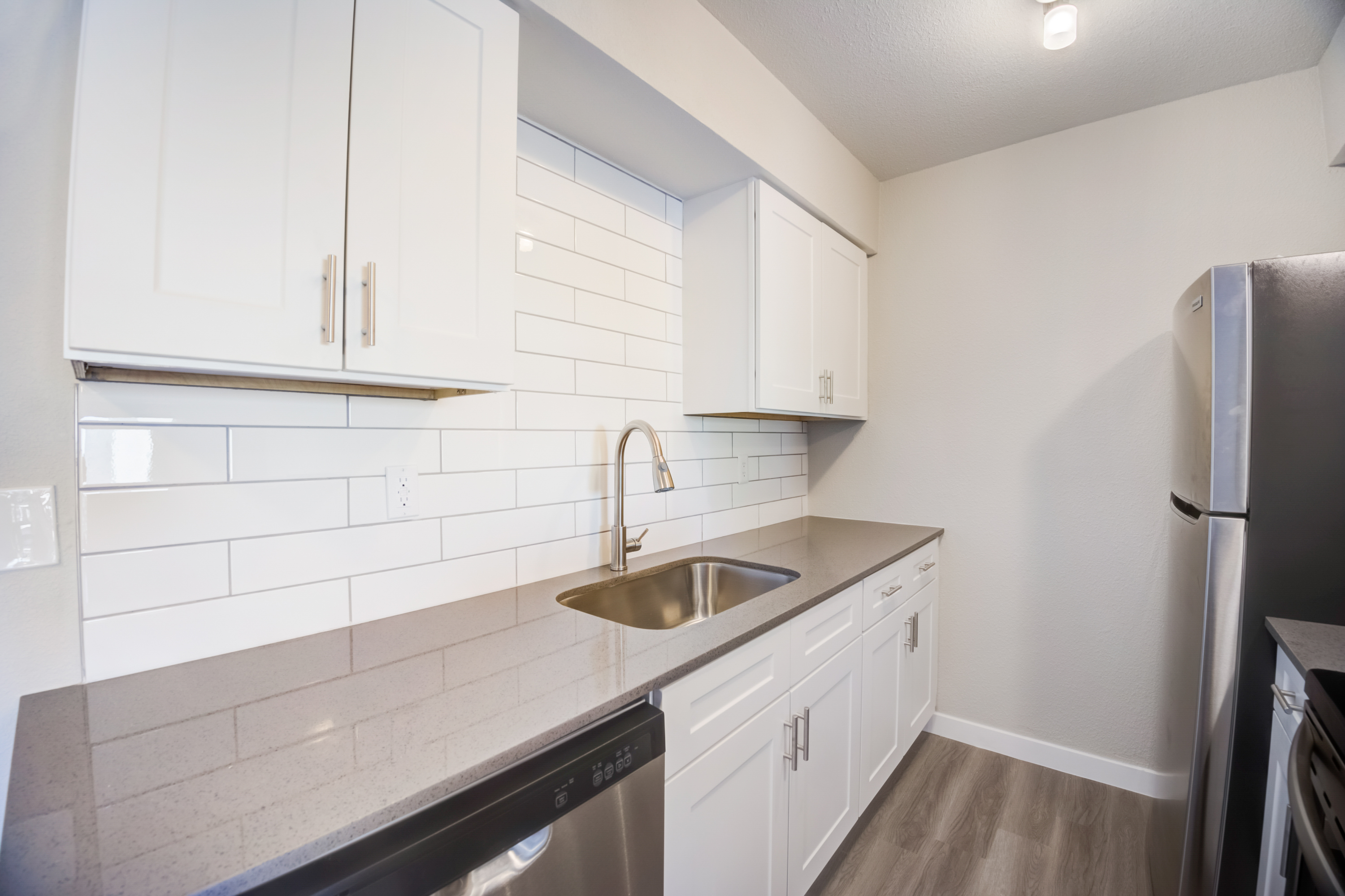 a kitchen with a sink and a mirror