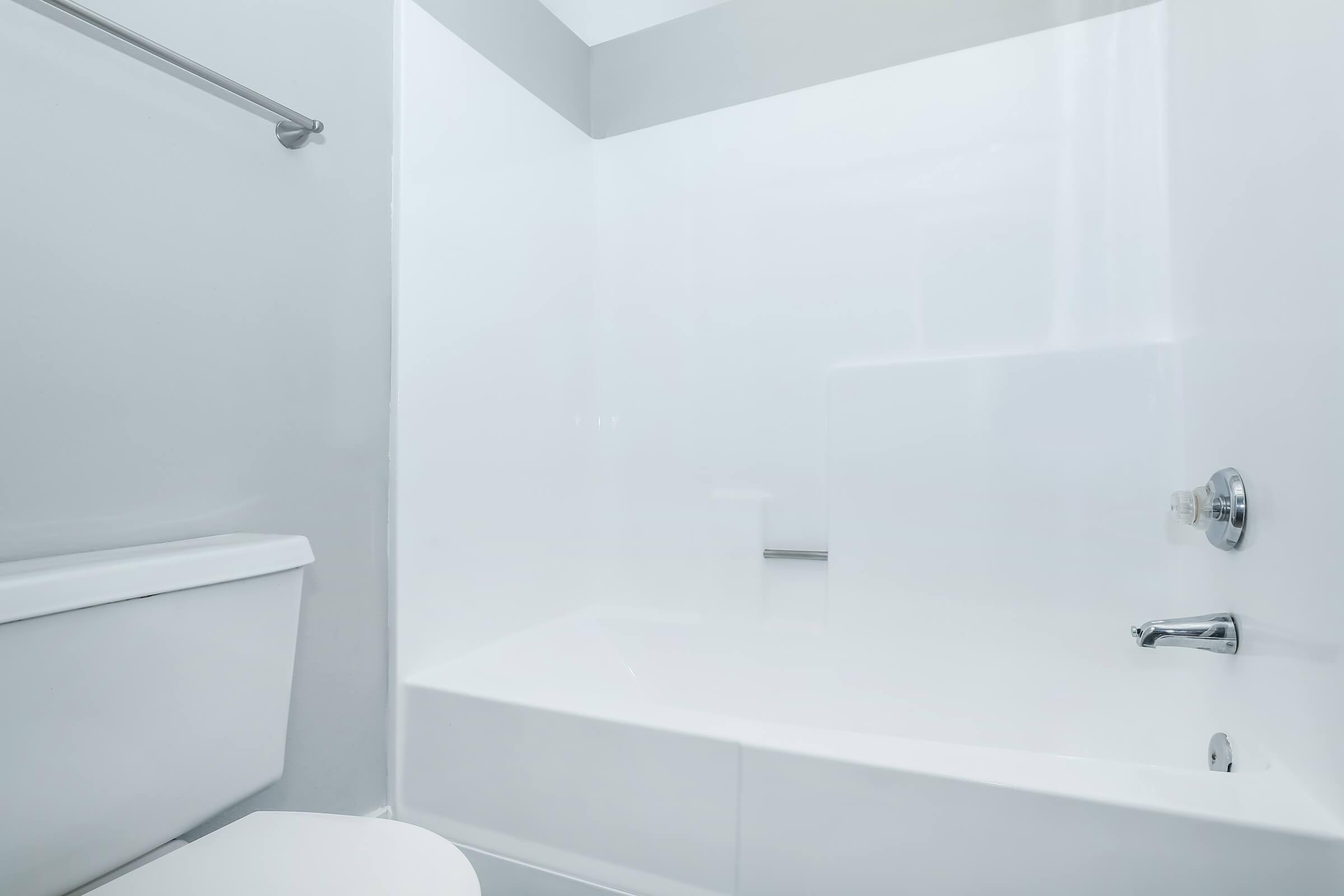 A white bathroom at Rise at the Meadows with a tub/shower.