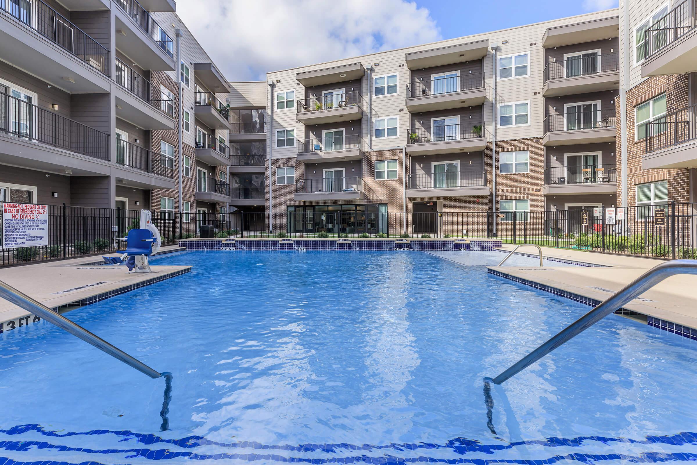 a blue pool of water in front of a building