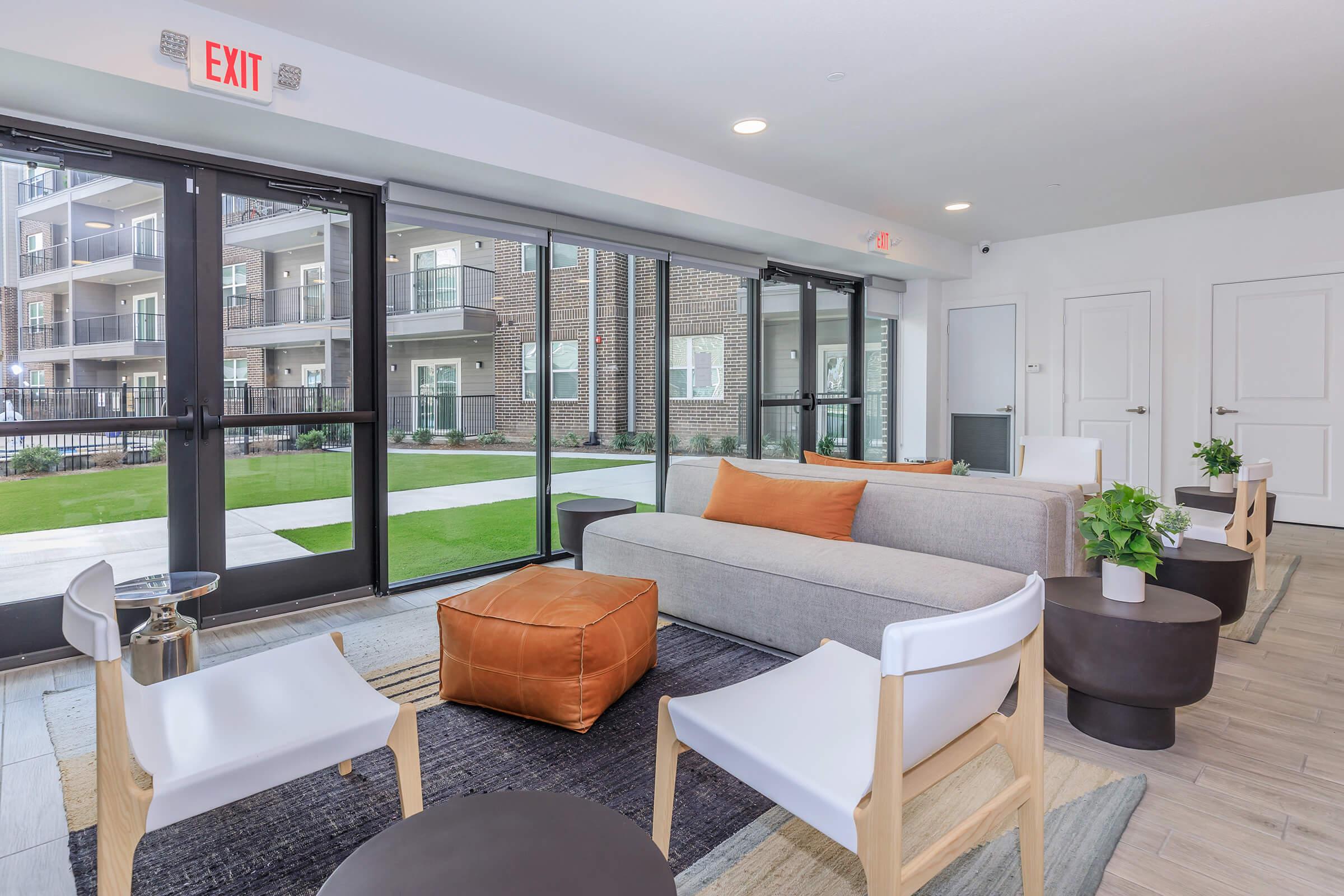 a living room filled with furniture and a large window