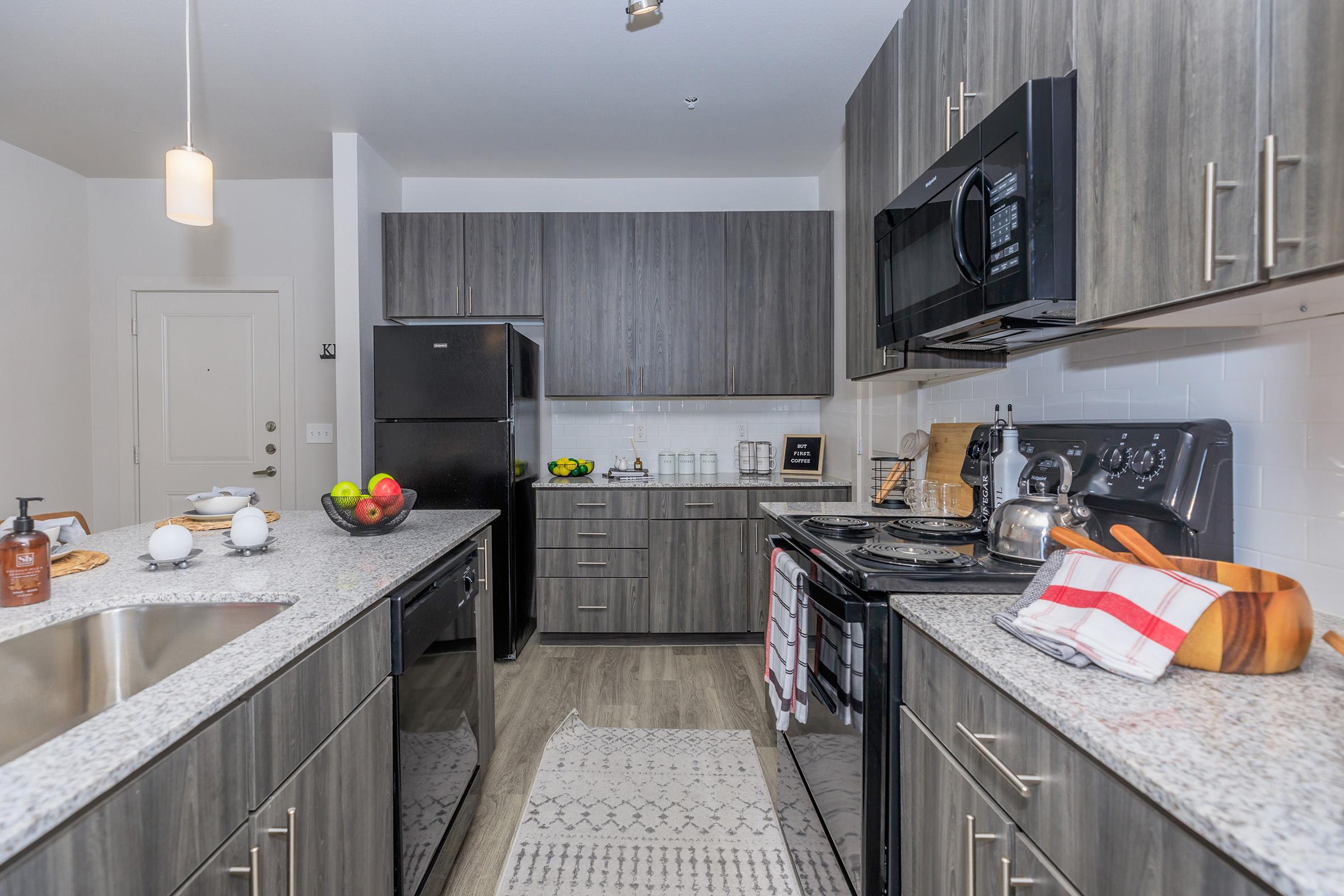 a modern kitchen with stainless steel appliances and wooden cabinets