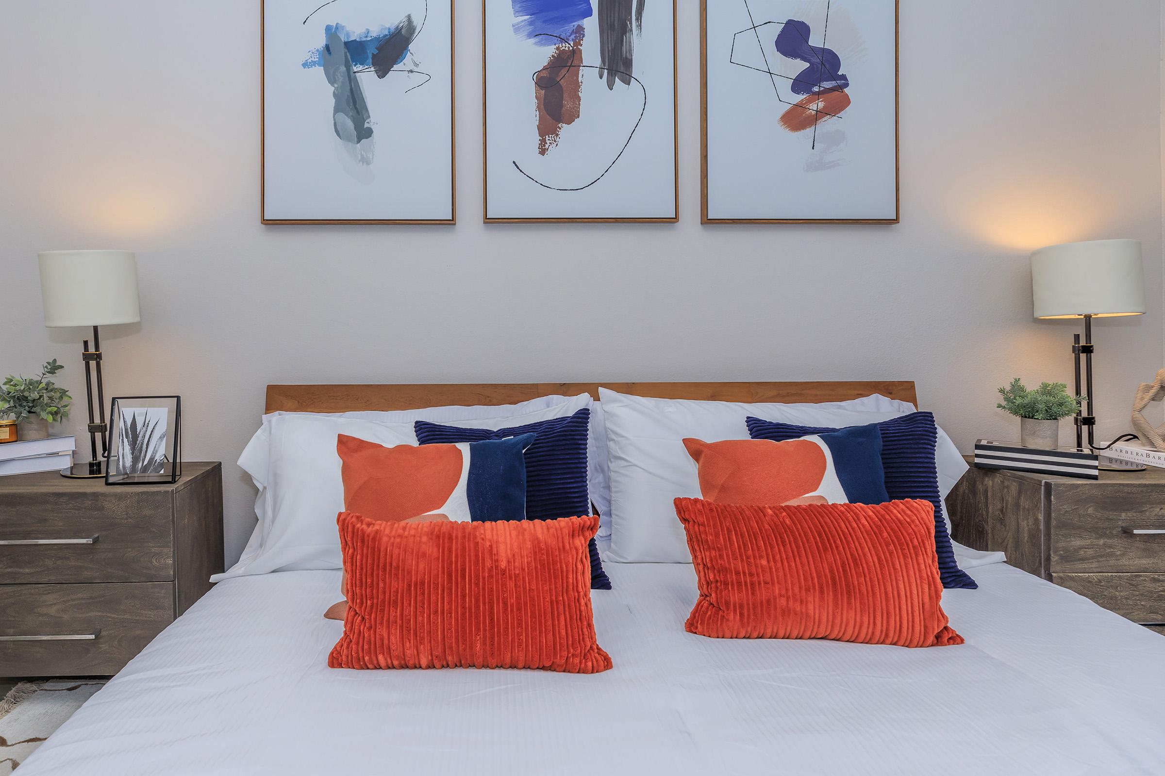 a bedroom with a neatly made bed in a hotel room