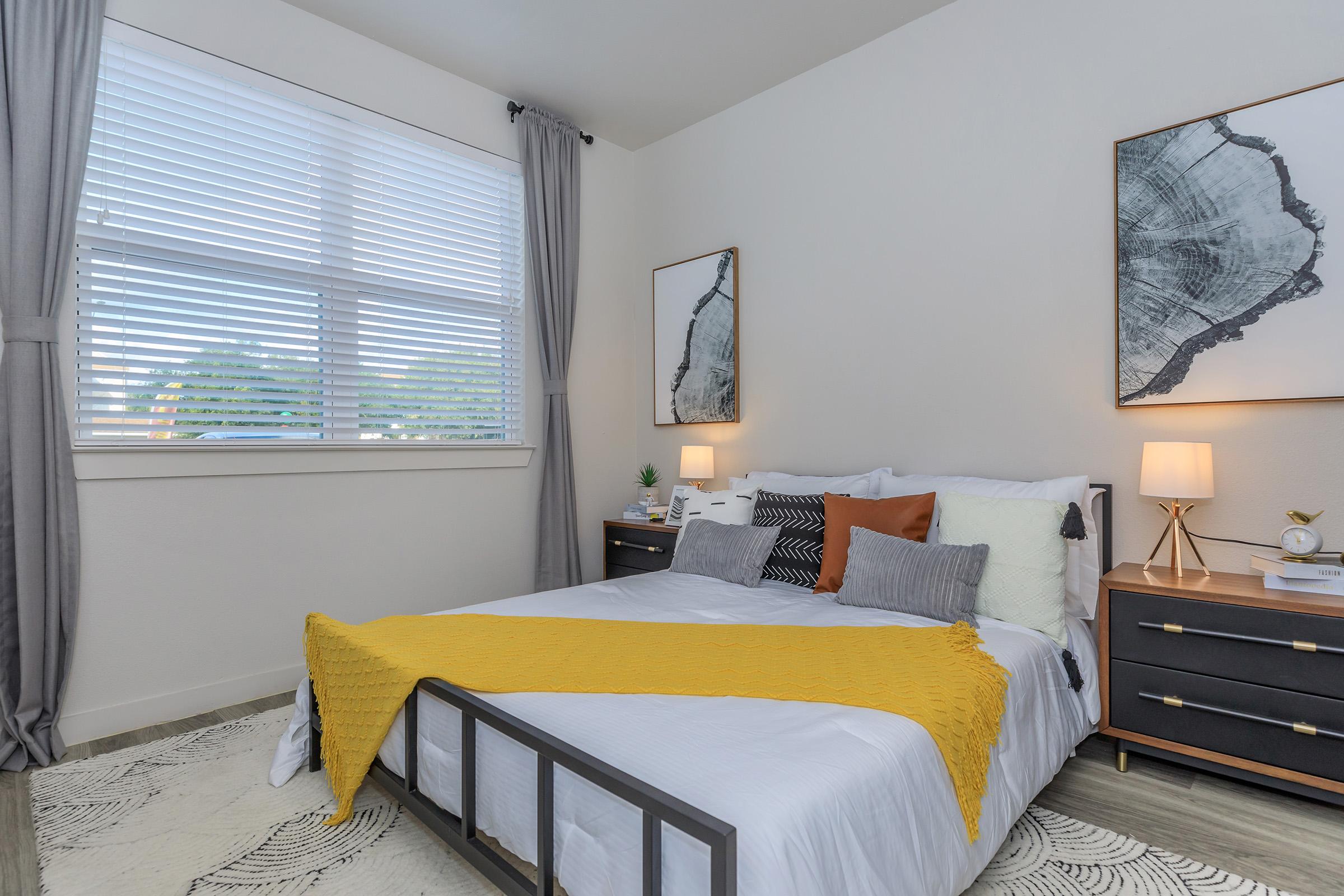 a bedroom with a bed and window in a room