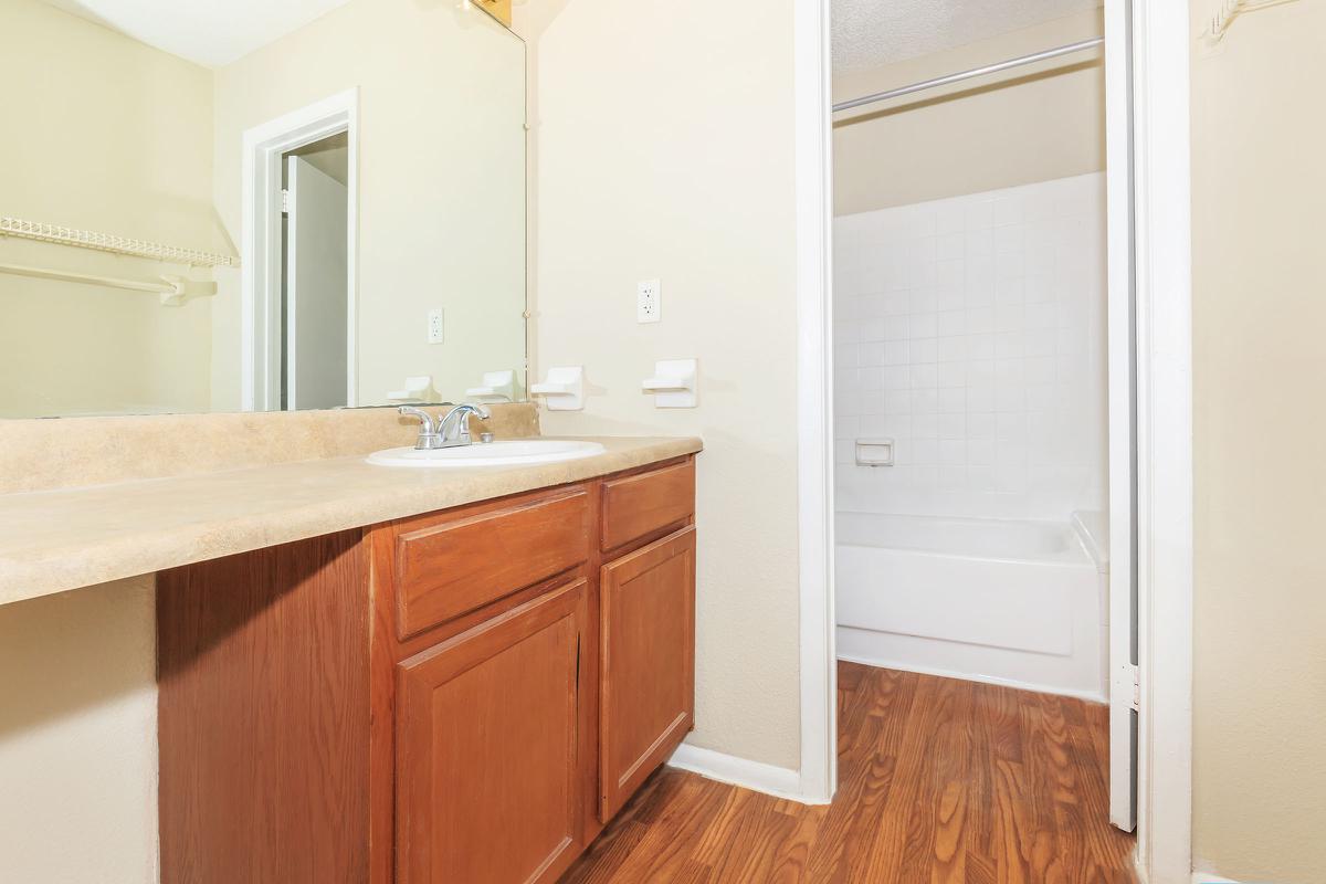 a kitchen with a sink and a mirror