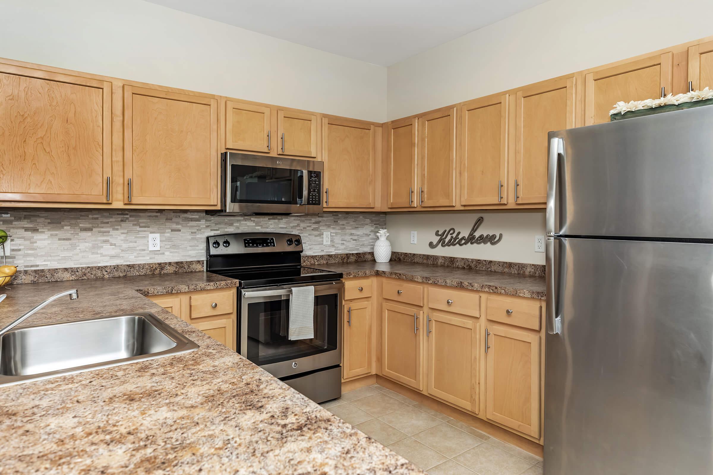 a kitchen with stainless steel appliances and wooden cabinets