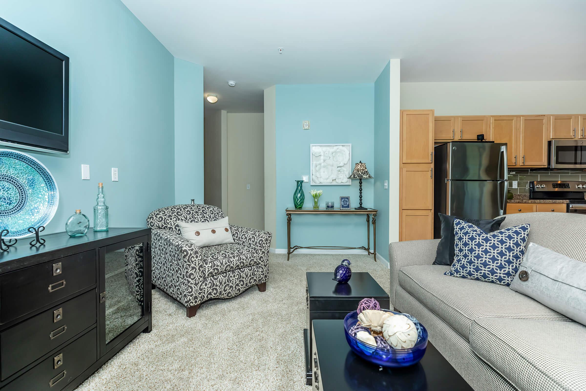 a living room filled with furniture and a flat screen tv