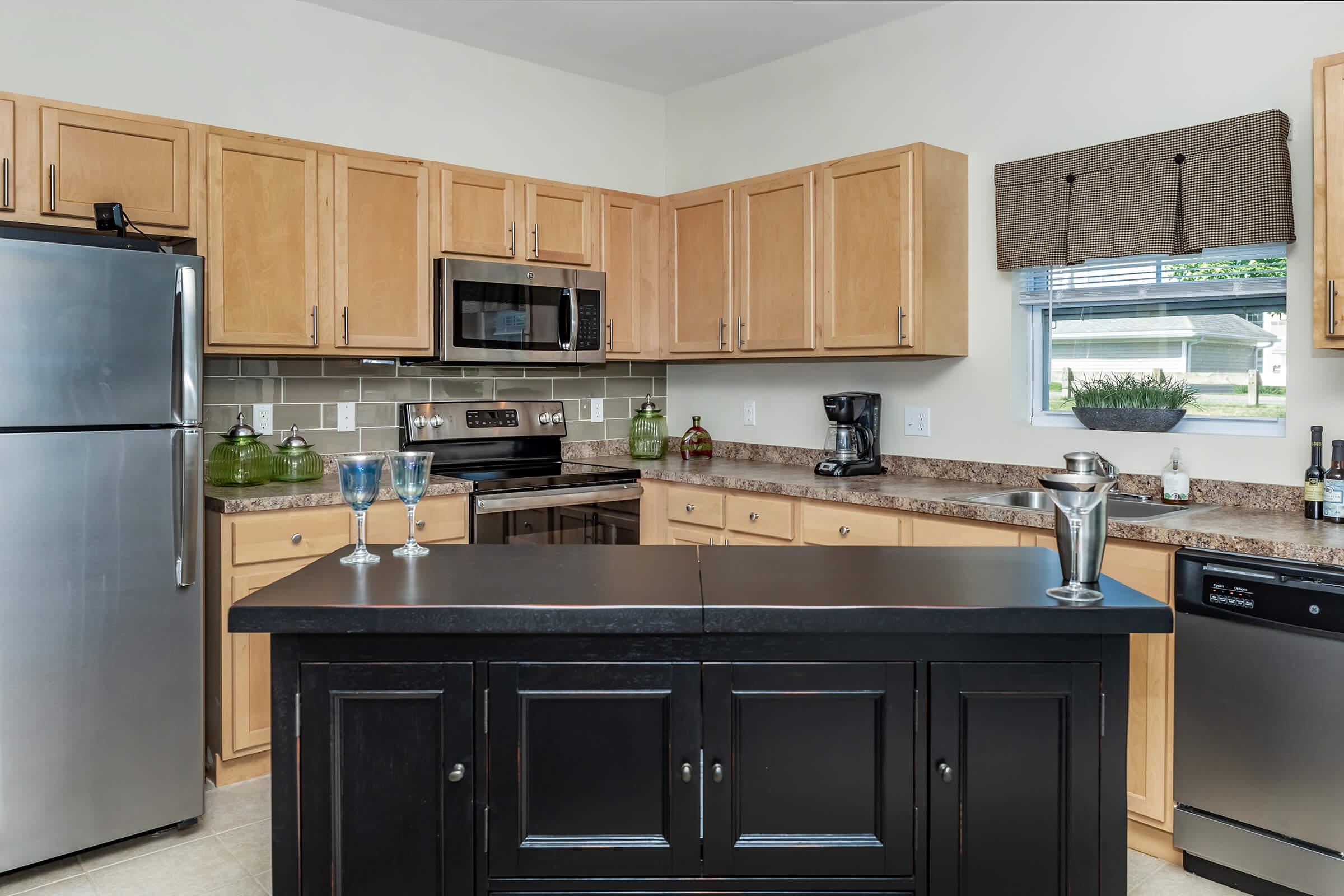 a kitchen with stainless steel appliances and wooden cabinets