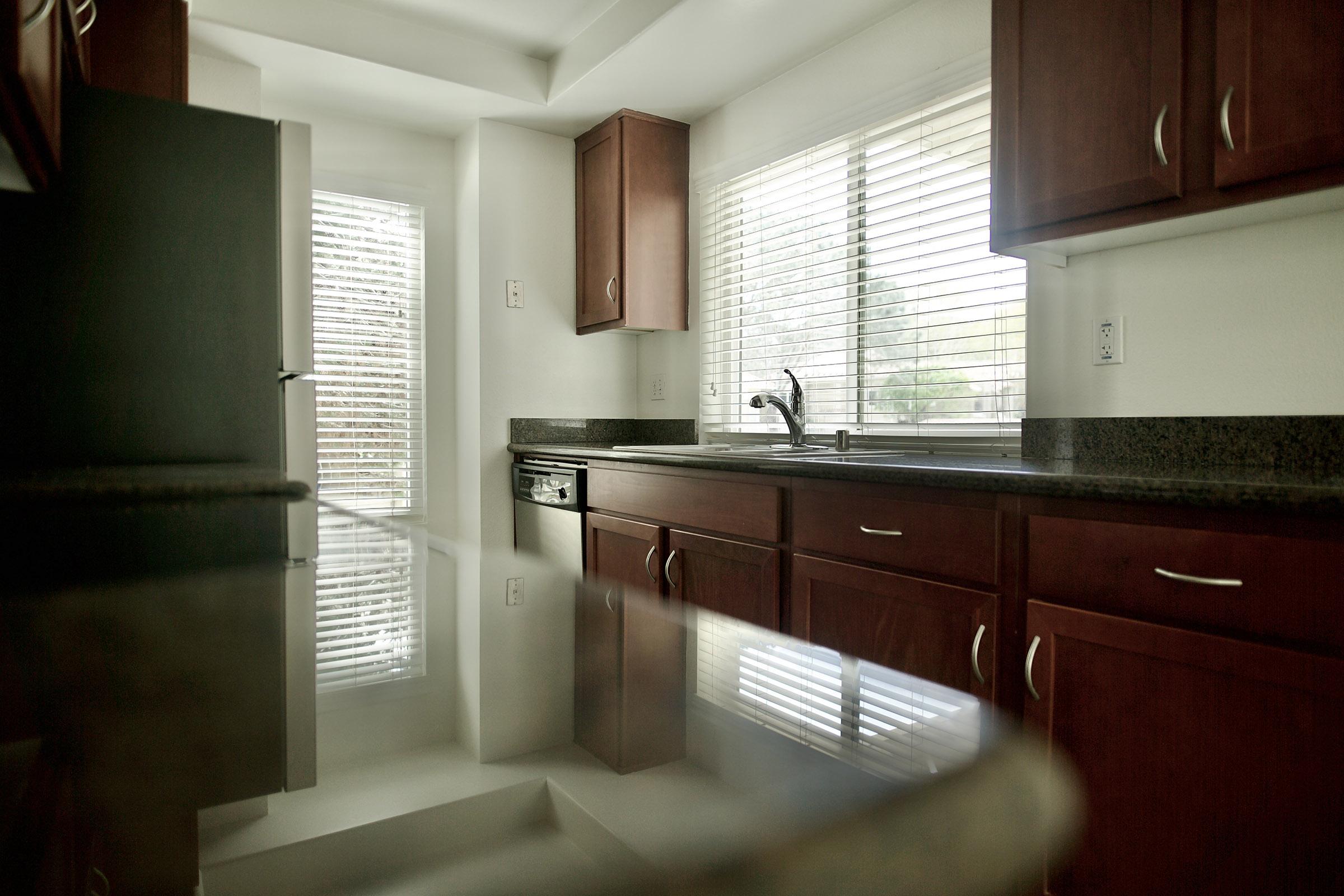 a kitchen with a sink mirror and window