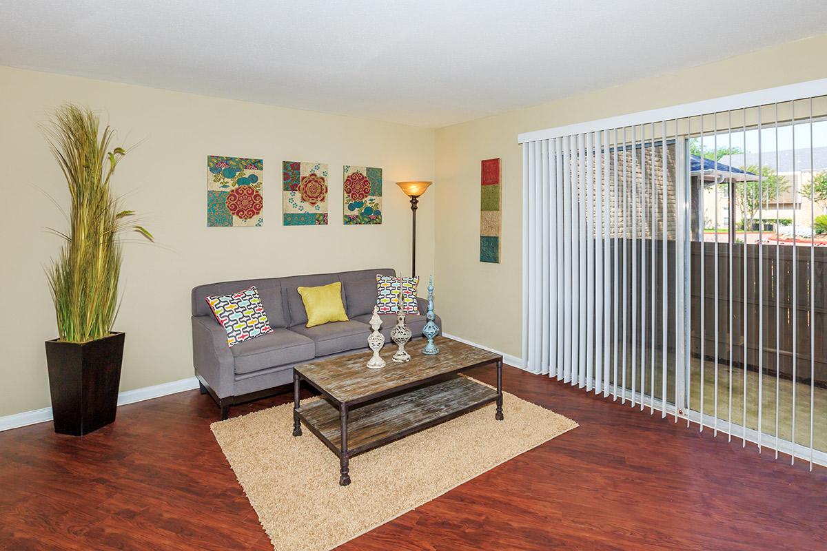 a living room filled with furniture and a large window