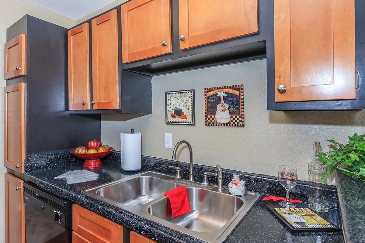 a kitchen with stainless steel appliances and wooden cabinets