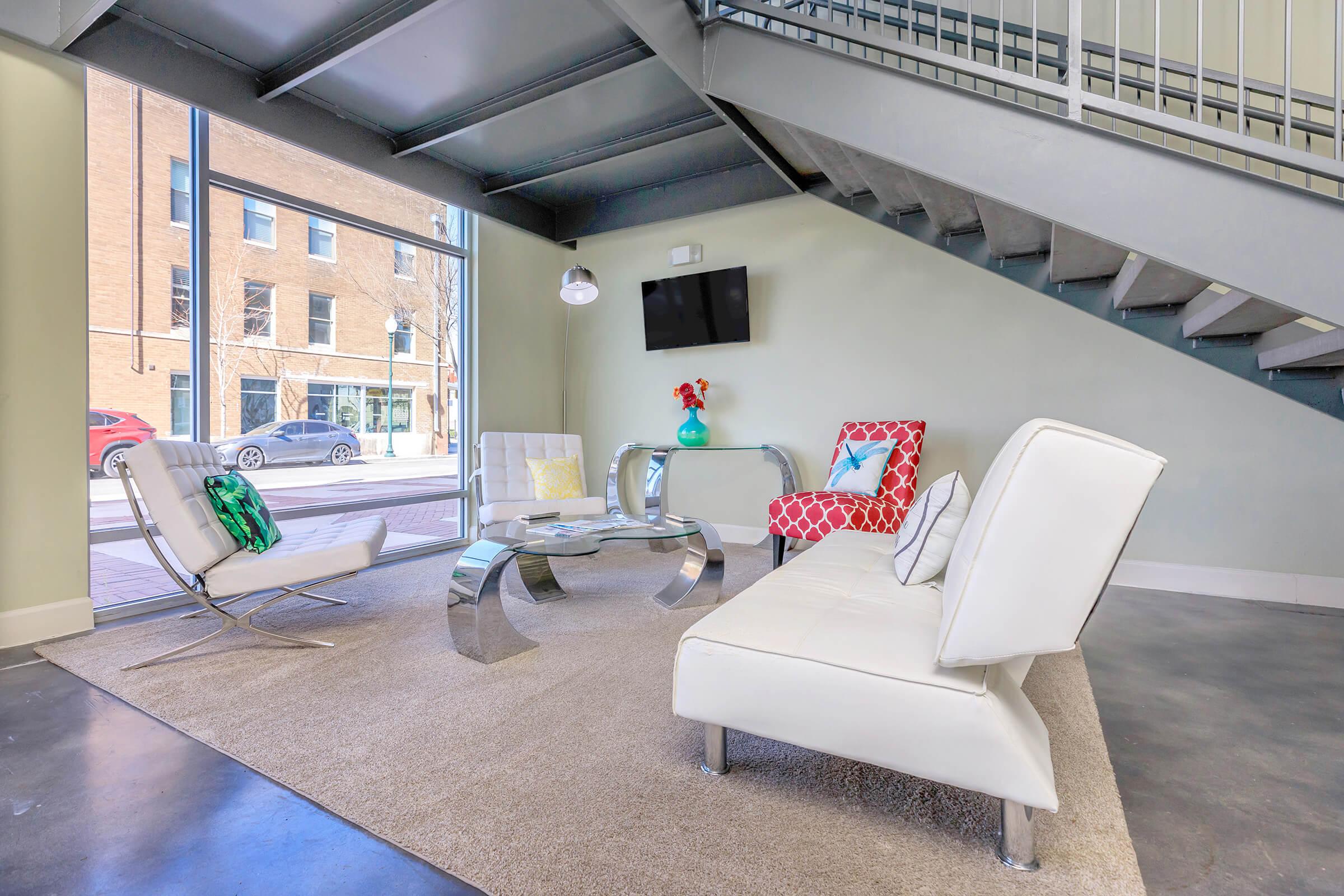 a room filled with furniture and a large window