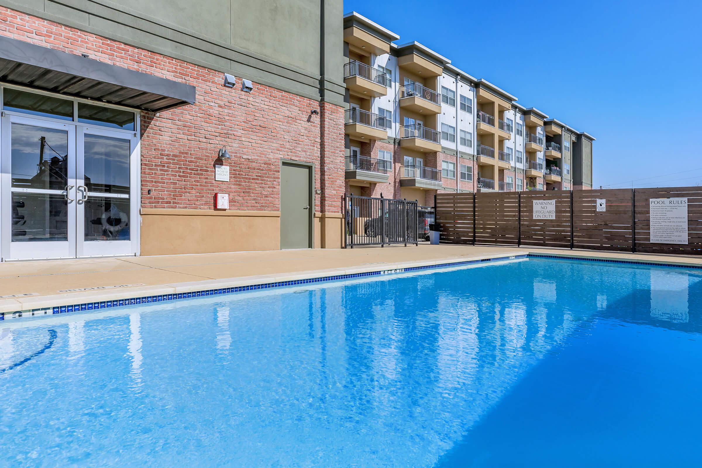 a person in a pool of water in front of a building