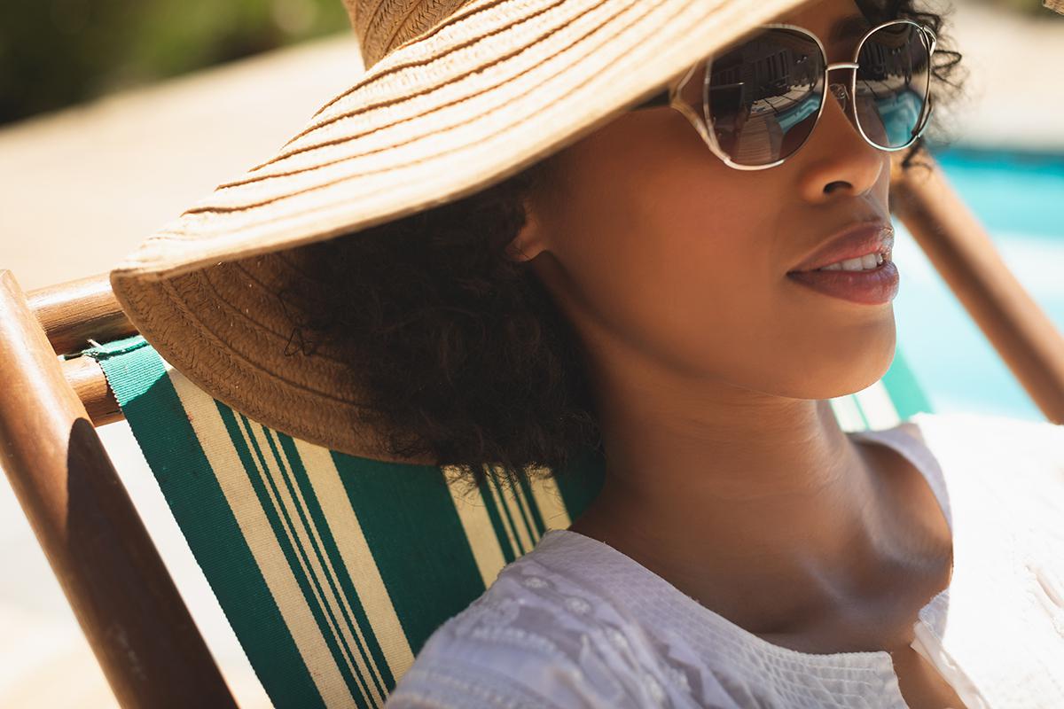 lady by the pool in hat.jpg