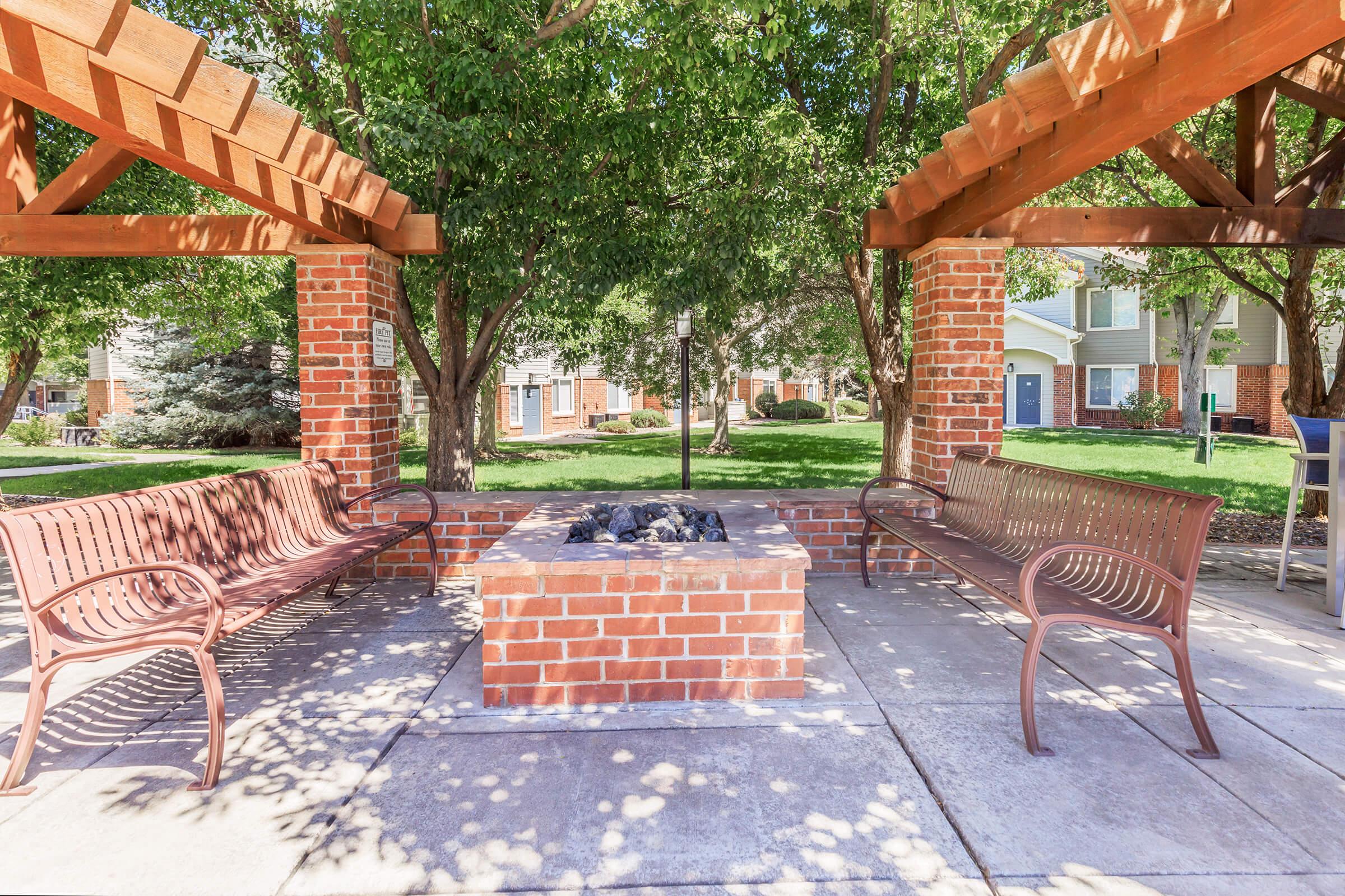 a bench in front of a brick building