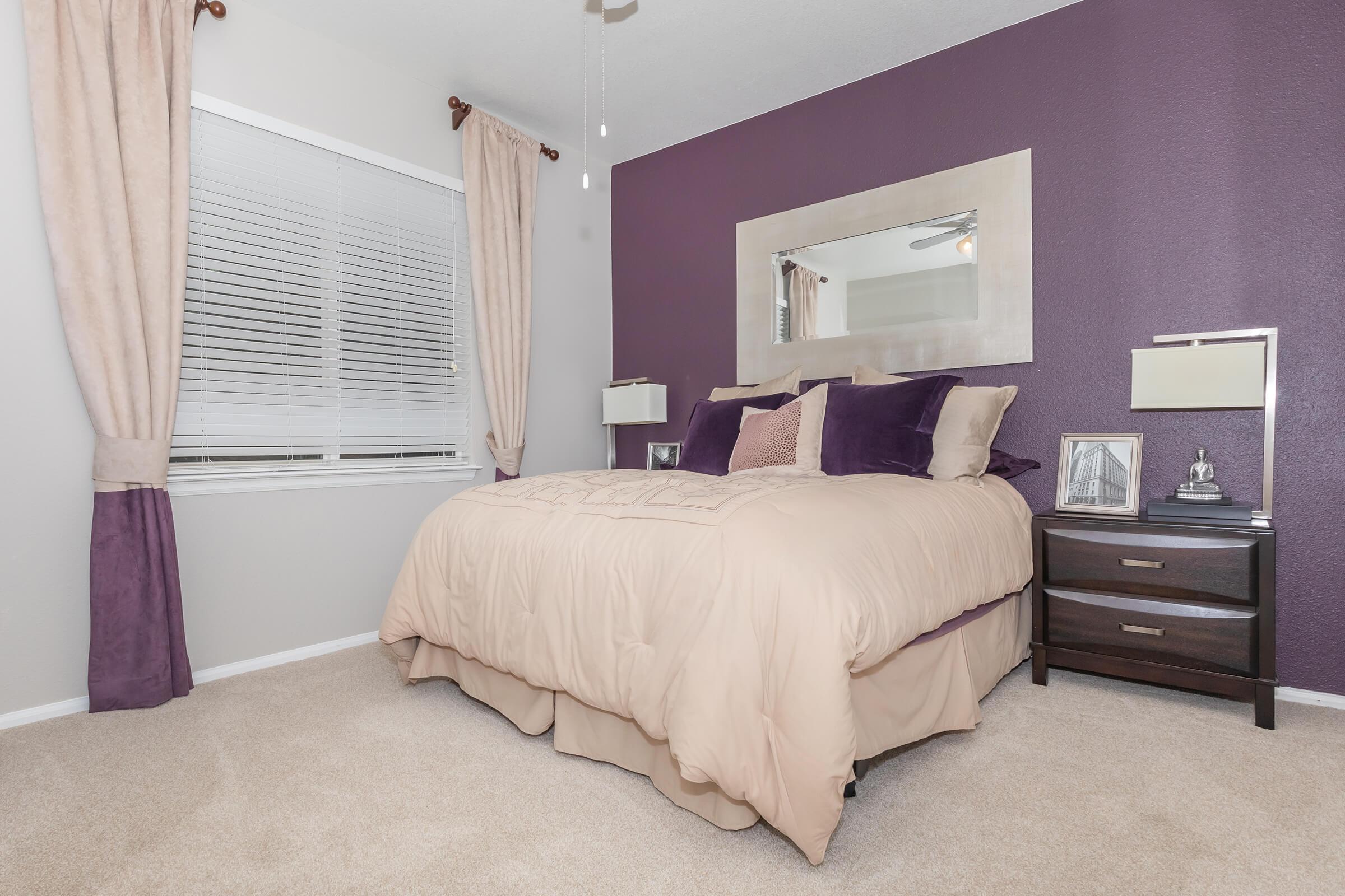 a bedroom with a bed in a room