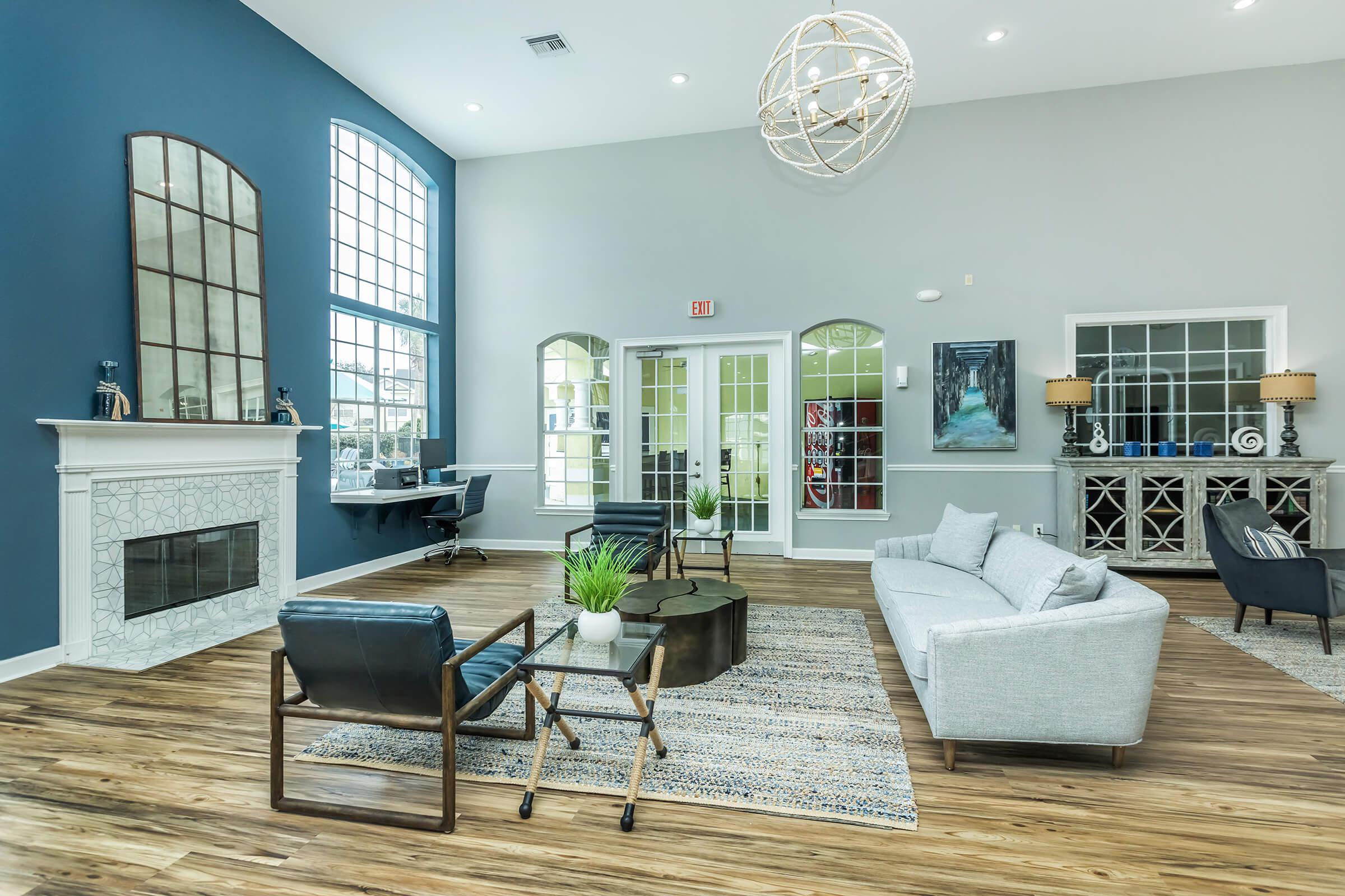 a living room filled with furniture and a large window