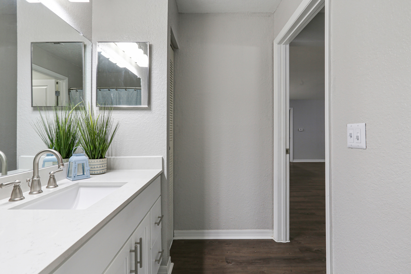 a kitchen with a sink and a mirror