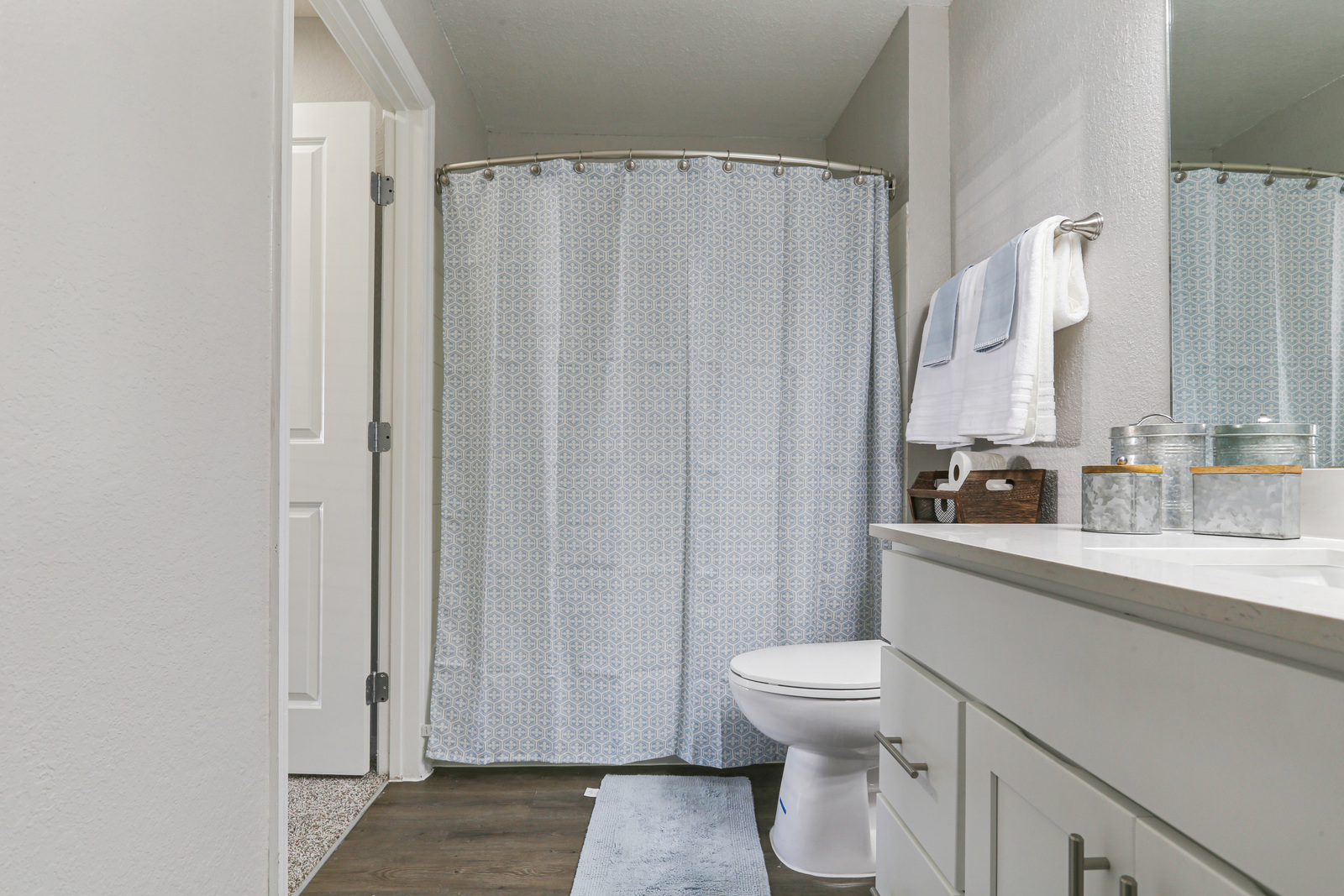 a shower curtain next to a sink